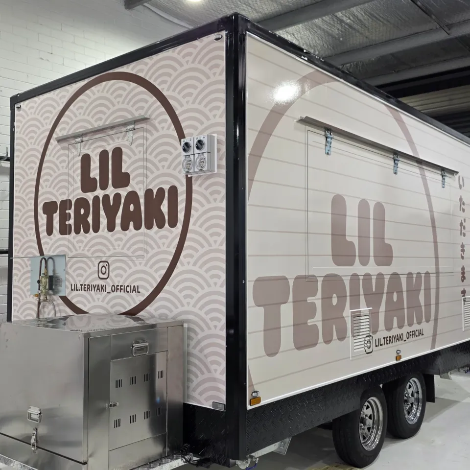 Lil Teriyaki food trailer with cream and brown branding and a repeating wave pattern