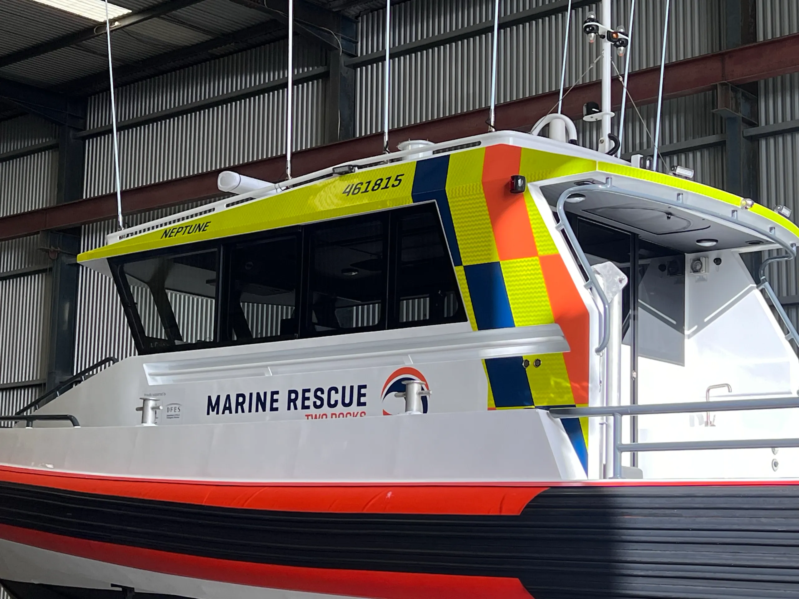 Neptune rescue boat cabin with Marine Rescue Two Rocks lettering and yellow, orange and navy graphics