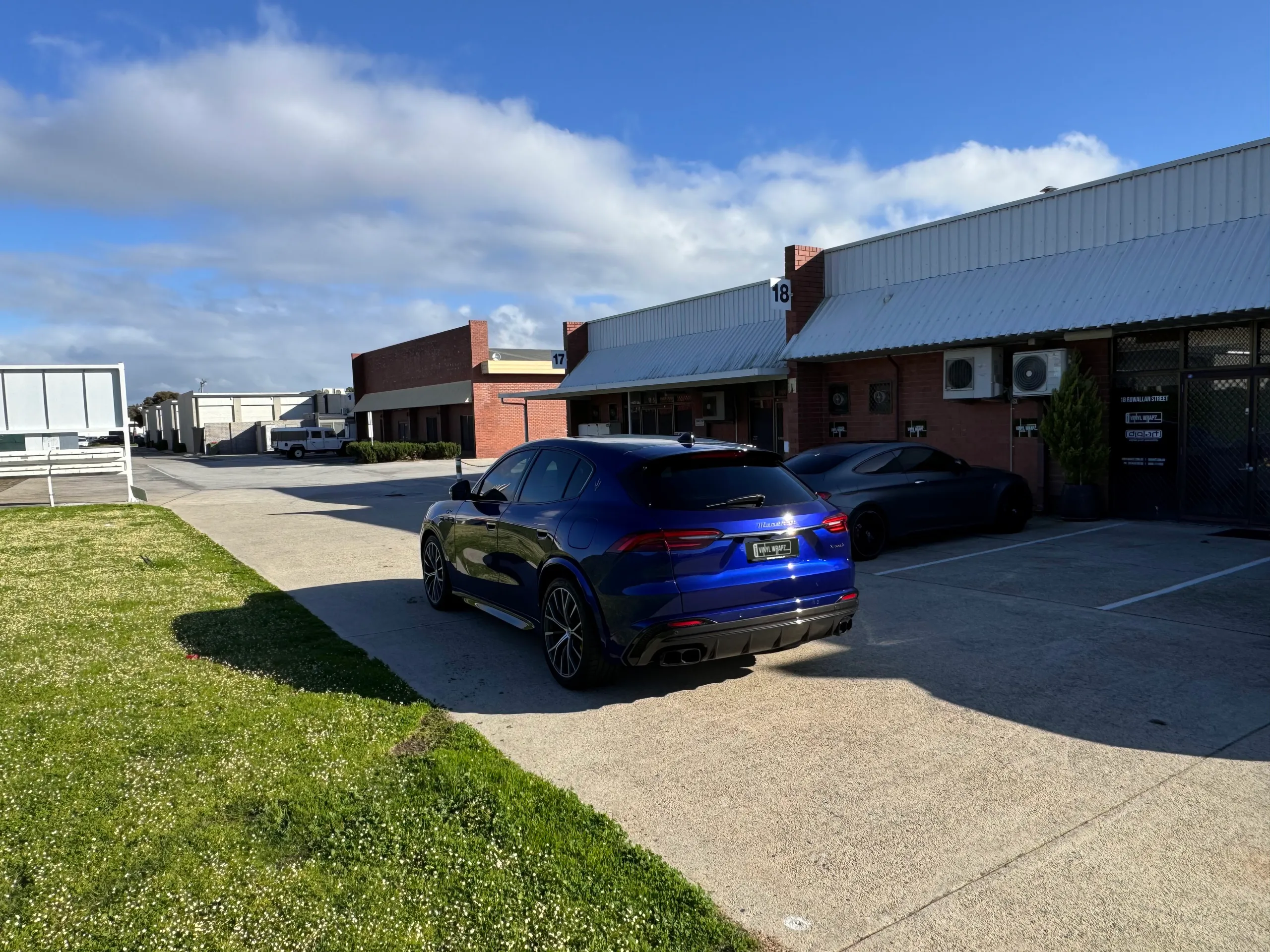 Wide outdoor view of the blue Maserati Grecale from the rear quarter