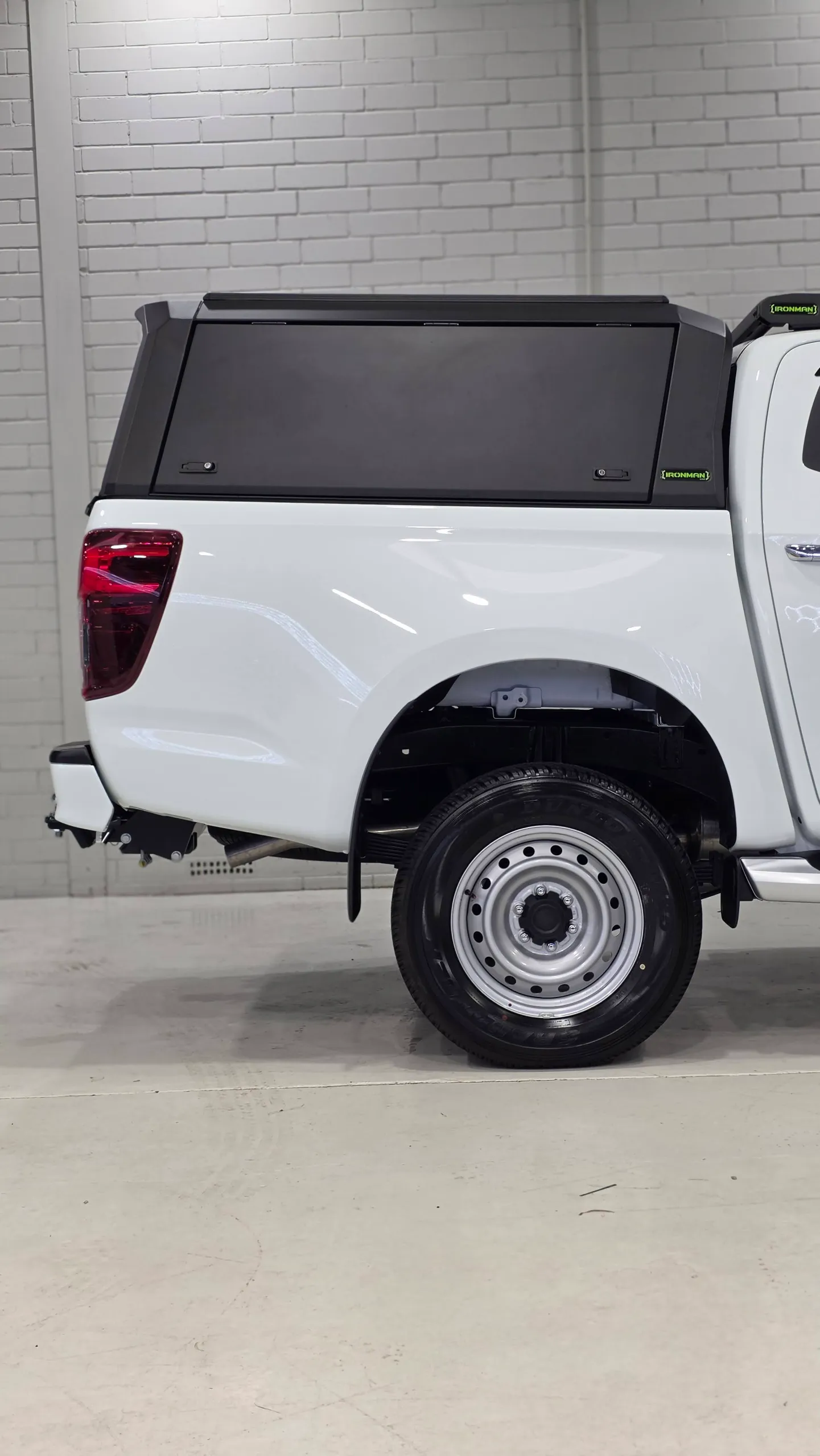 Rear wheel, white tray body and black canopy on the Mazda BT-50