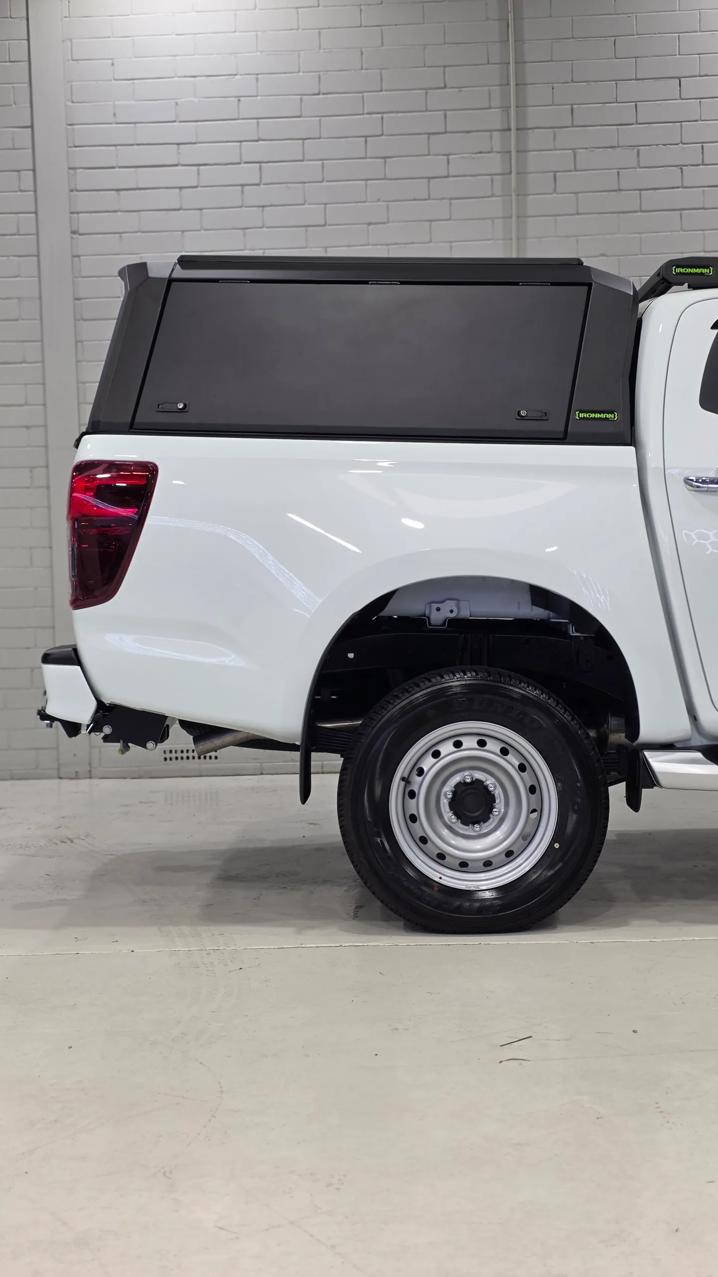 White rear bodywork and rear wheel beneath the Mazda BT-50 canopy