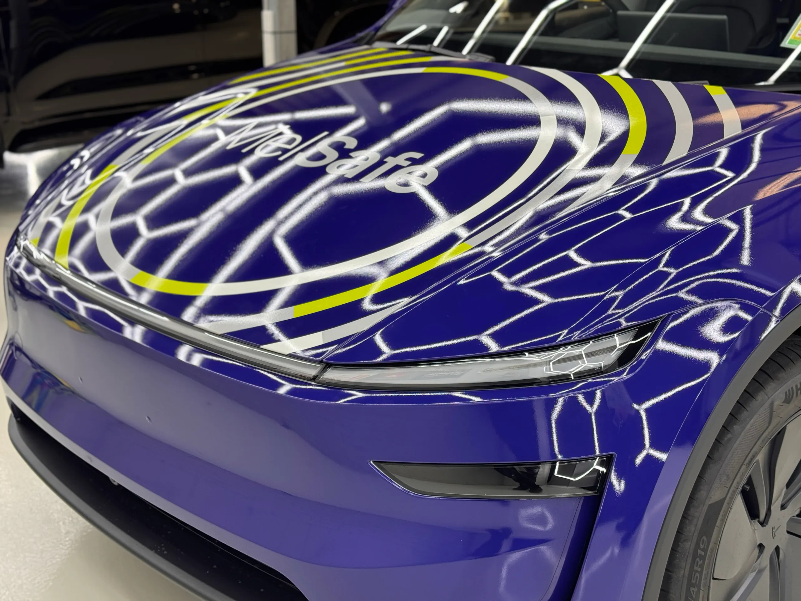 MelSafe bonnet lettering and white and yellow rings on the blue Tesla