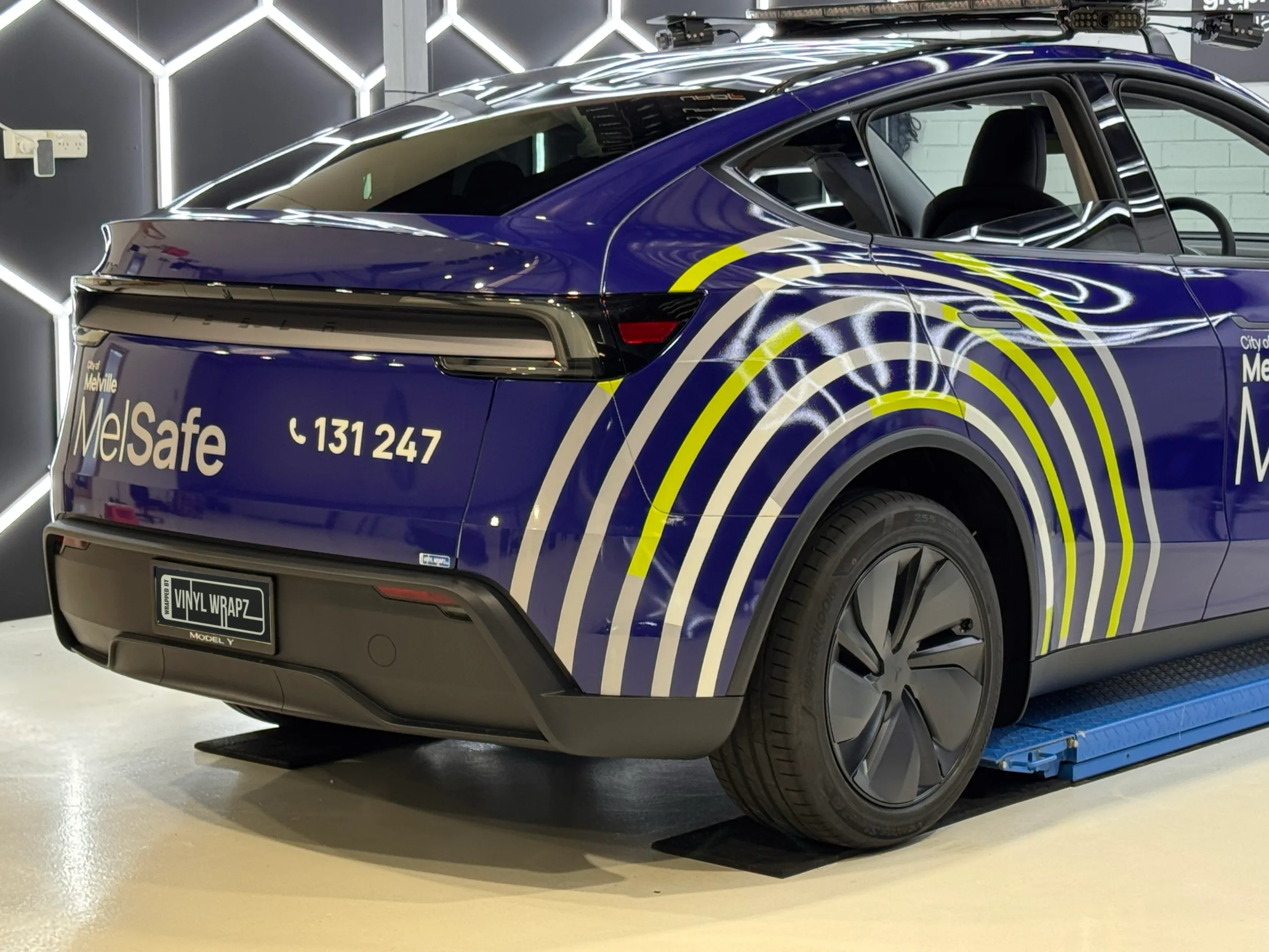MelSafe Tesla Model Y tailgate and rear quarter with white and yellow circular graphics