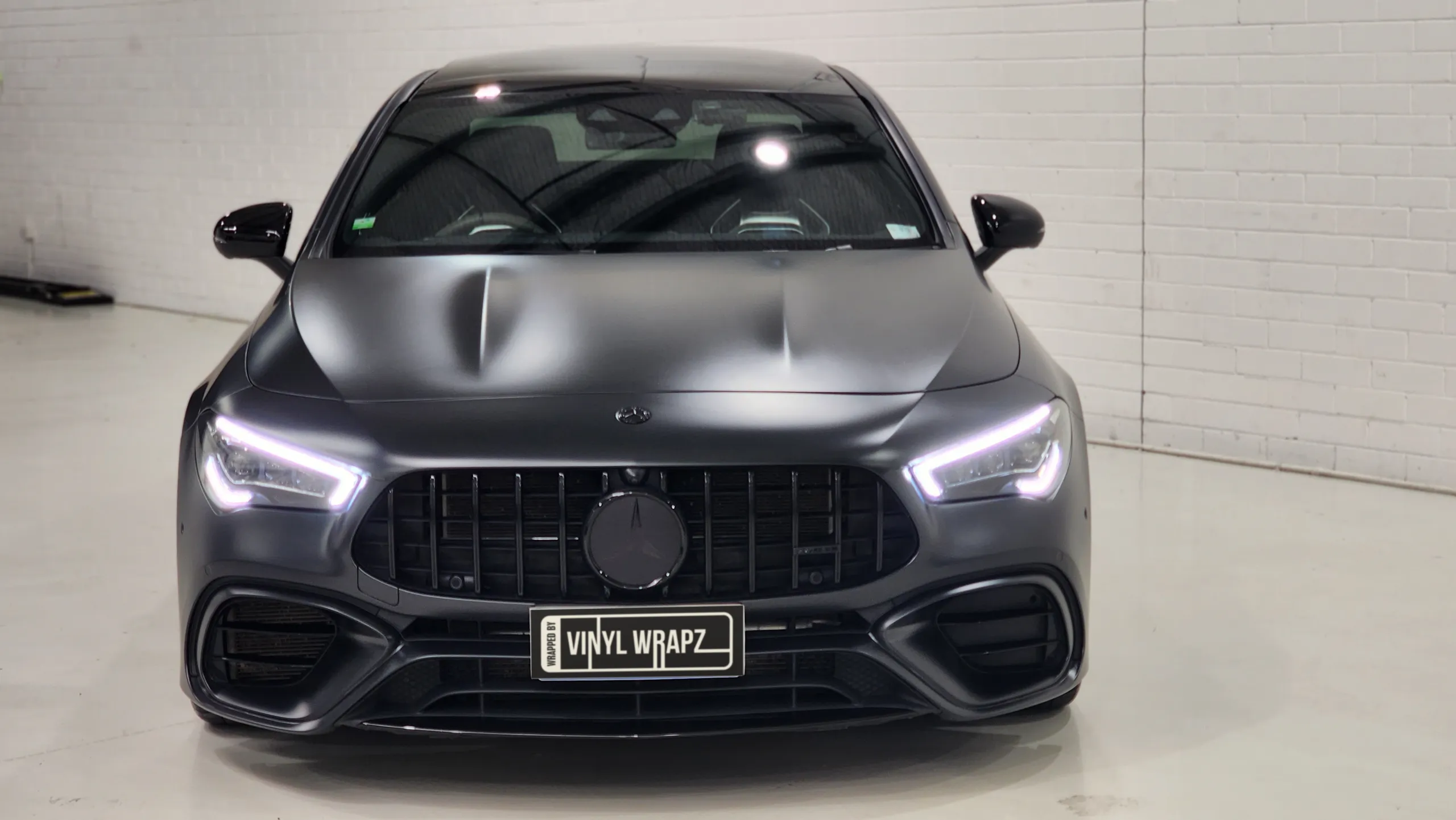 Mercedes-AMG CLA 45 S with satin dark grey bodywork and illuminated headlights