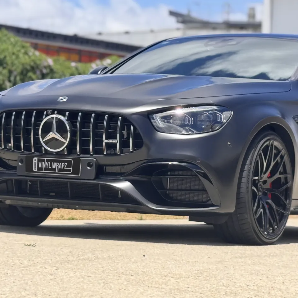 Satin black Mercedes-AMG E63 grille, headlight and front wheel outdoors