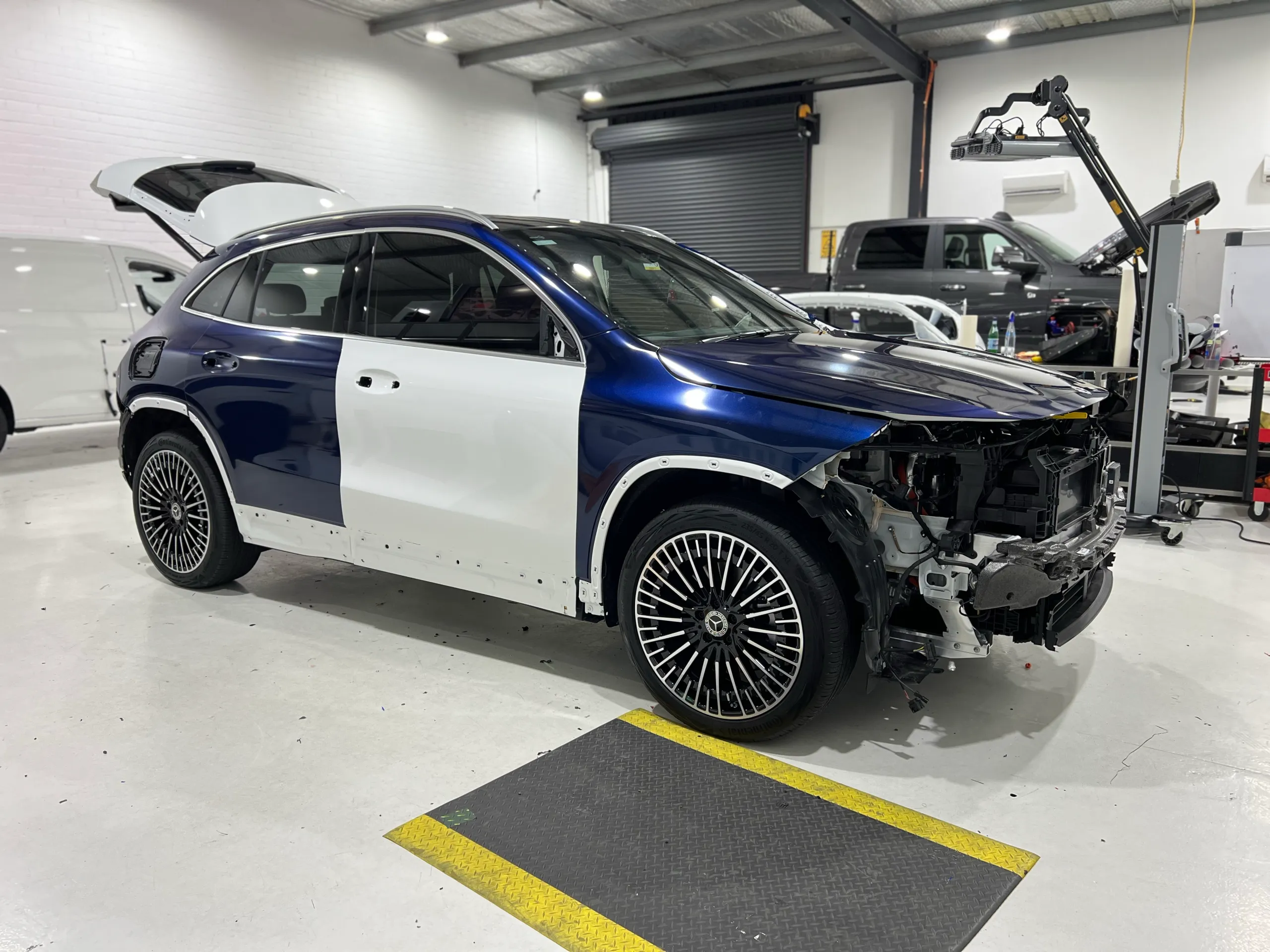 Blue and black iridescent Mercedes-Benz EQA, front quarter