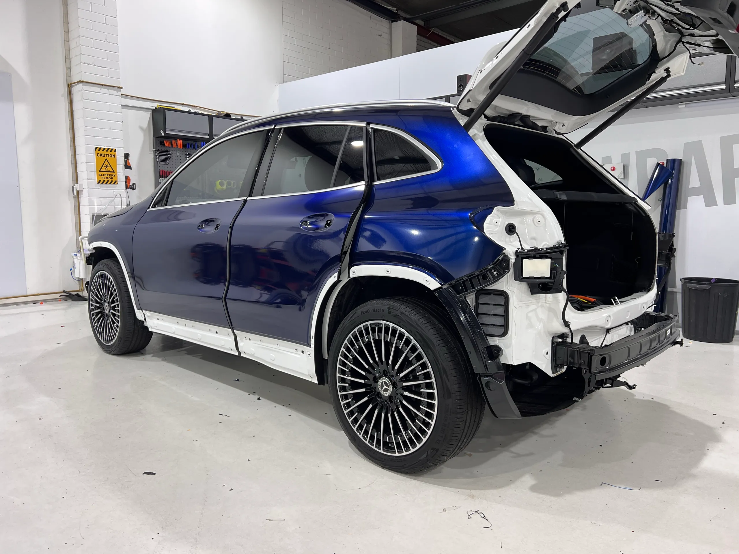 Blue and black iridescent Mercedes-Benz EQA, rear quarter