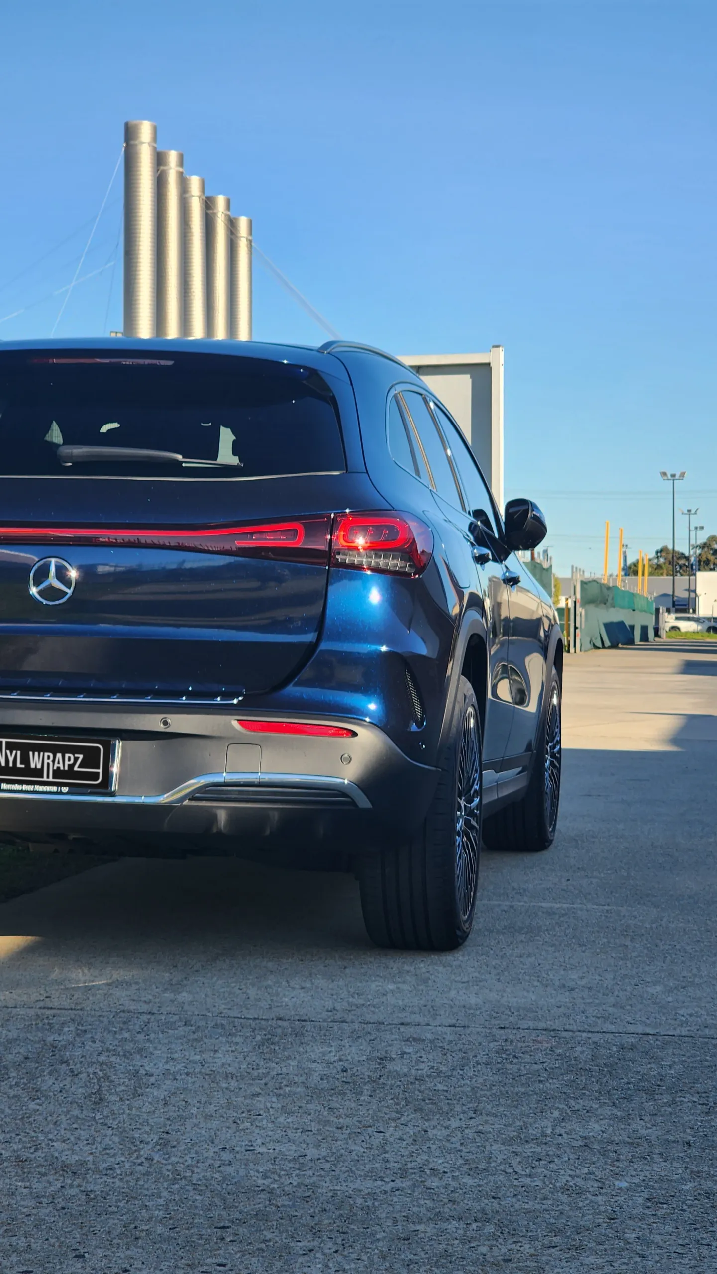 Blue and black iridescent Mercedes-Benz EQA, rear quarter