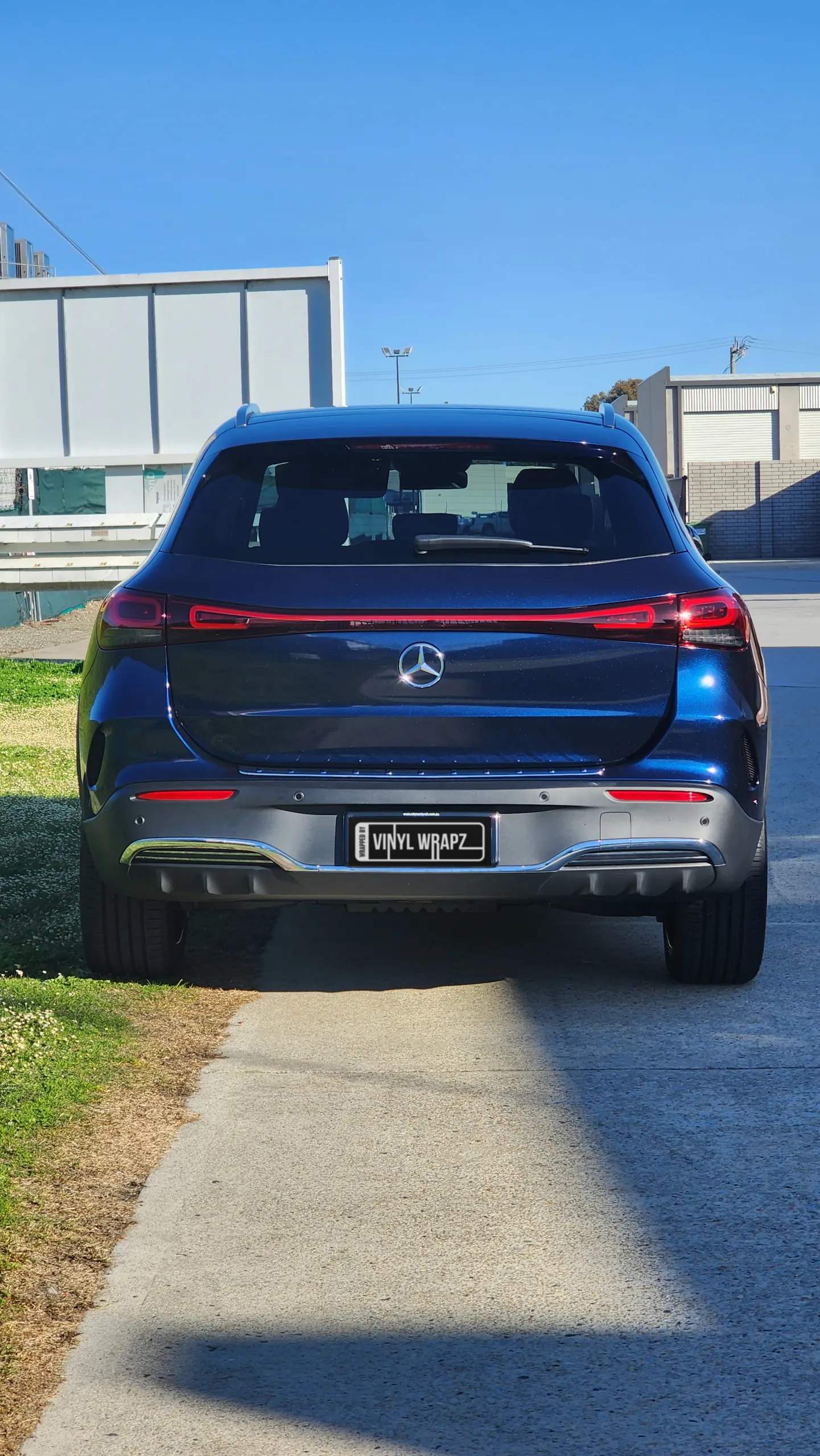 Blue and black iridescent Mercedes-Benz EQA, rear