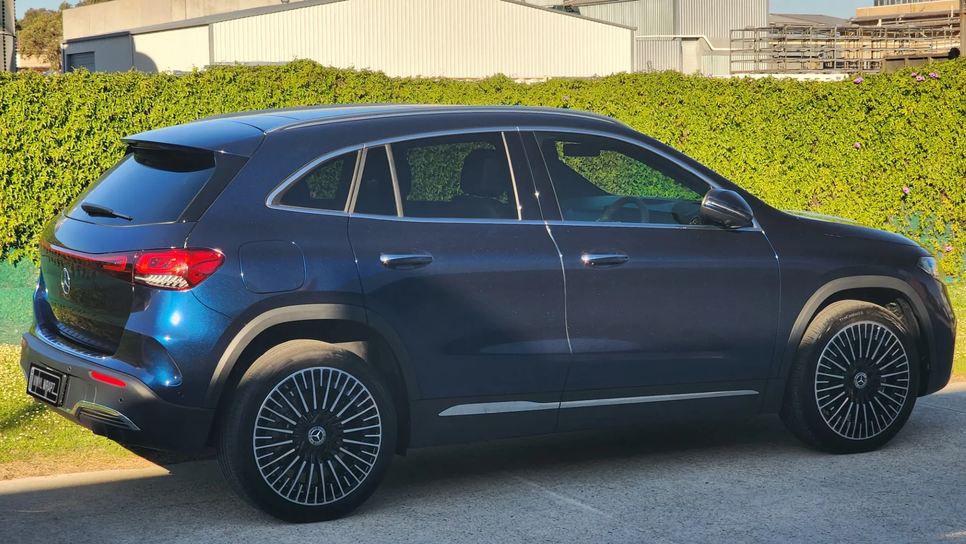 Blue and black iridescent Mercedes-Benz EQA, rear quarter