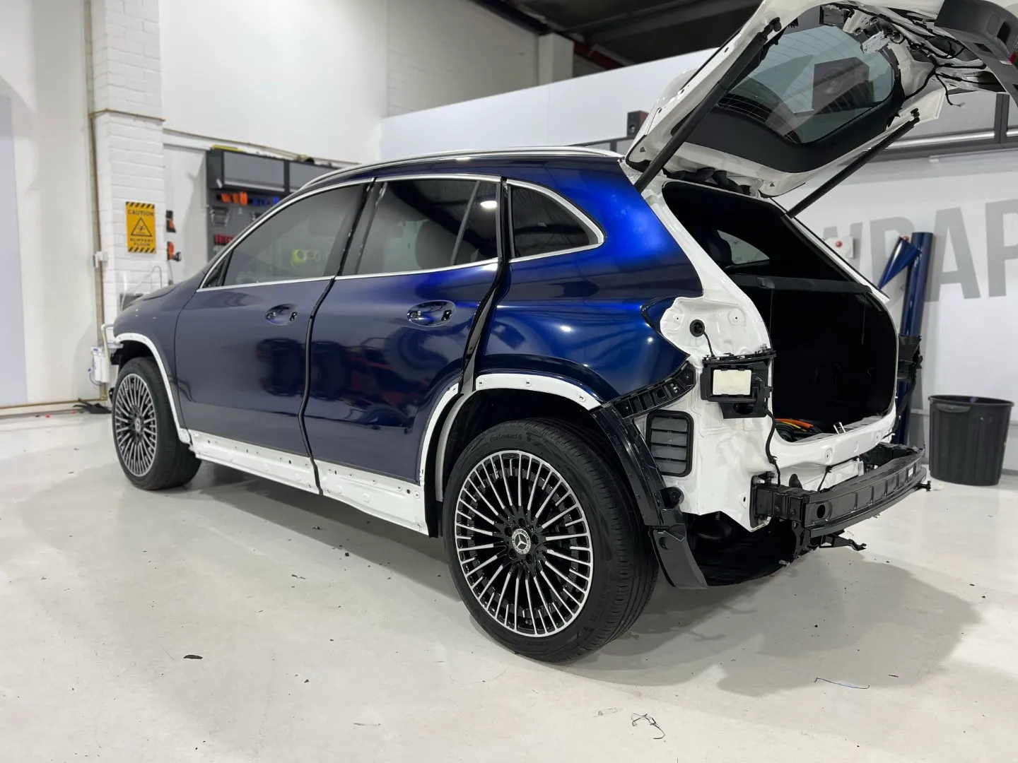 Blue and black iridescent Mercedes-Benz EQA, rear quarter