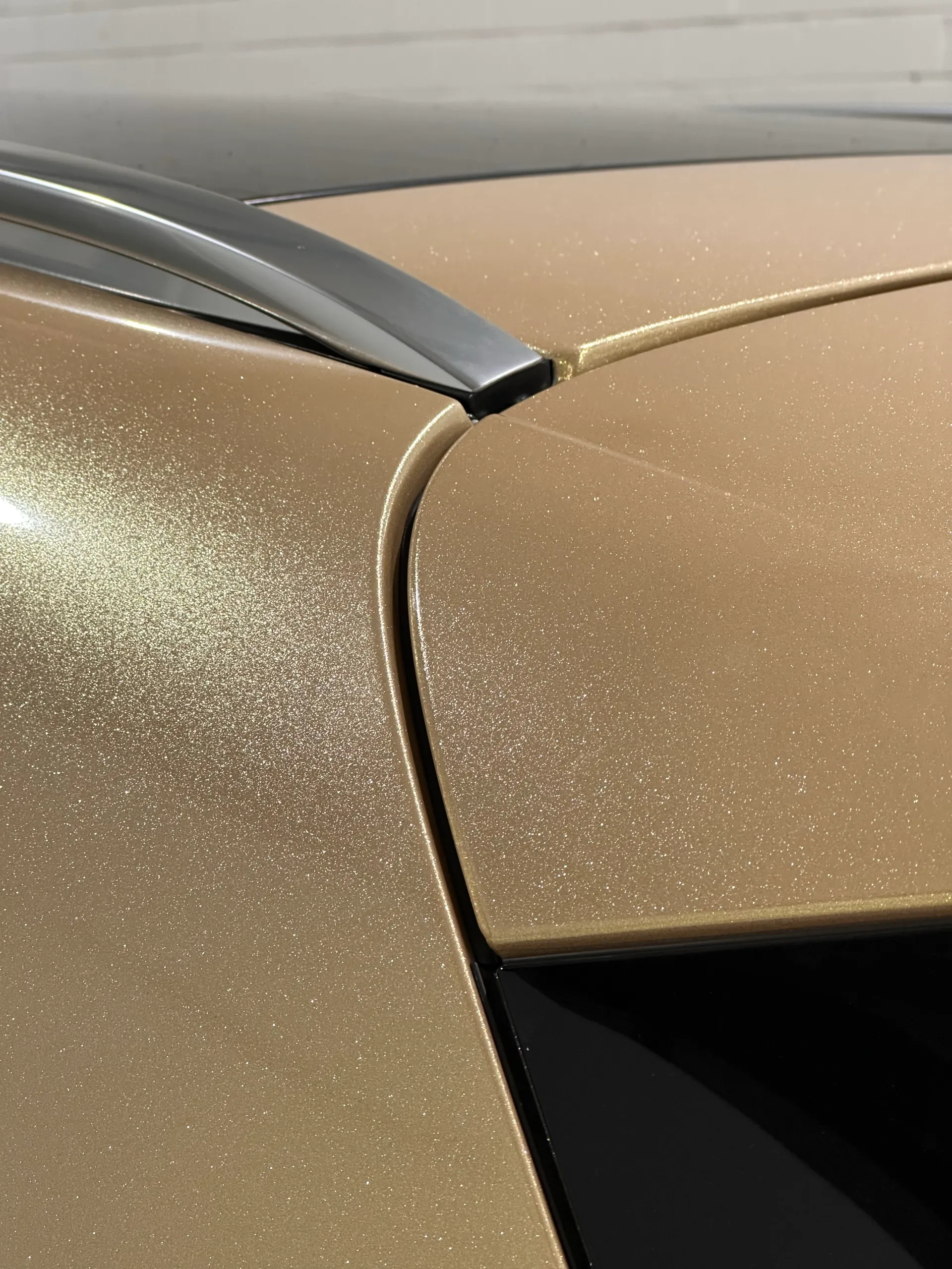Fine sparkle in the gold Mercedes-Benz GLA finish beside its window trim