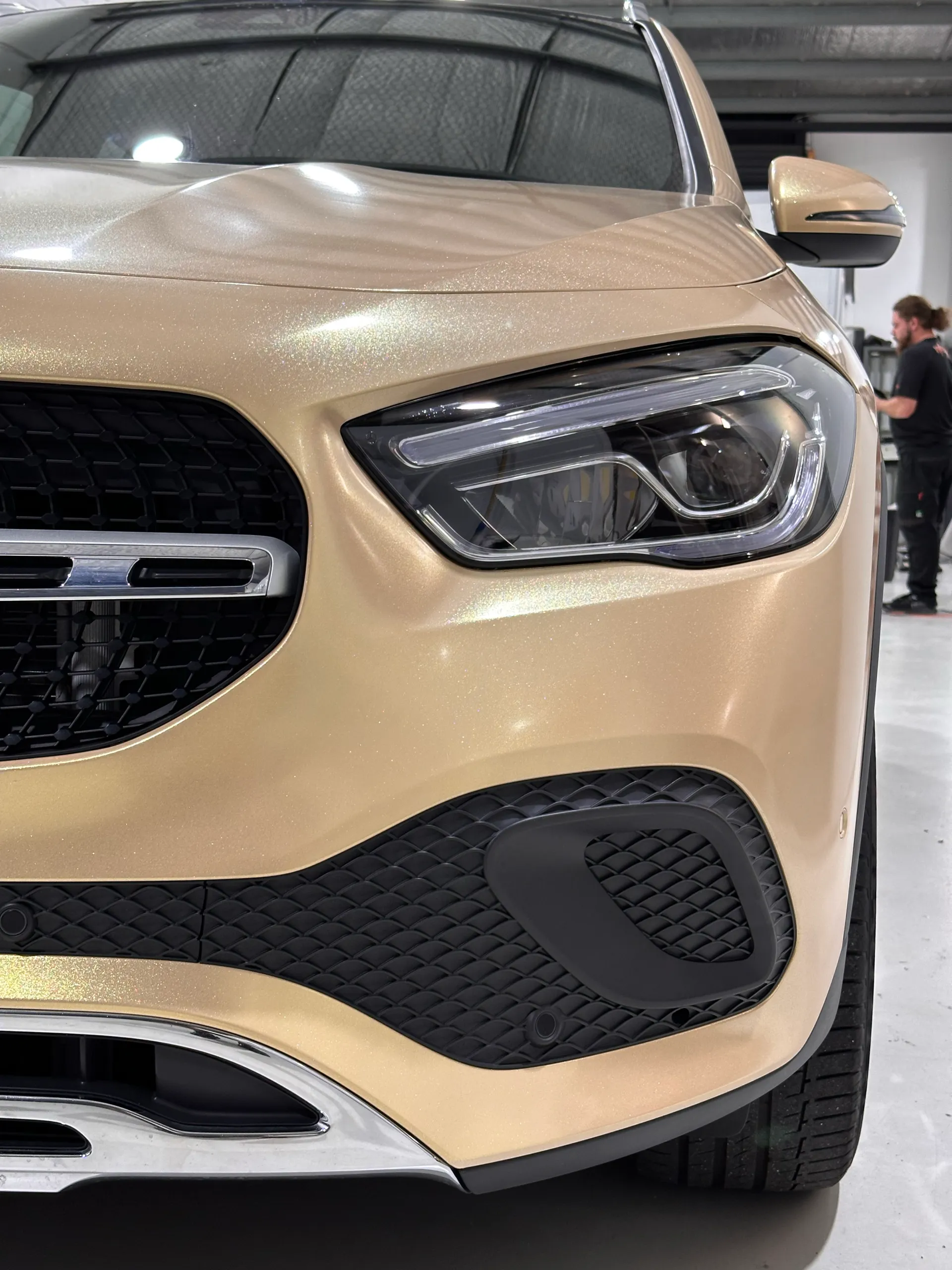 Mercedes-Benz GLA grille and headlight surrounded by gold shimmer bodywork
