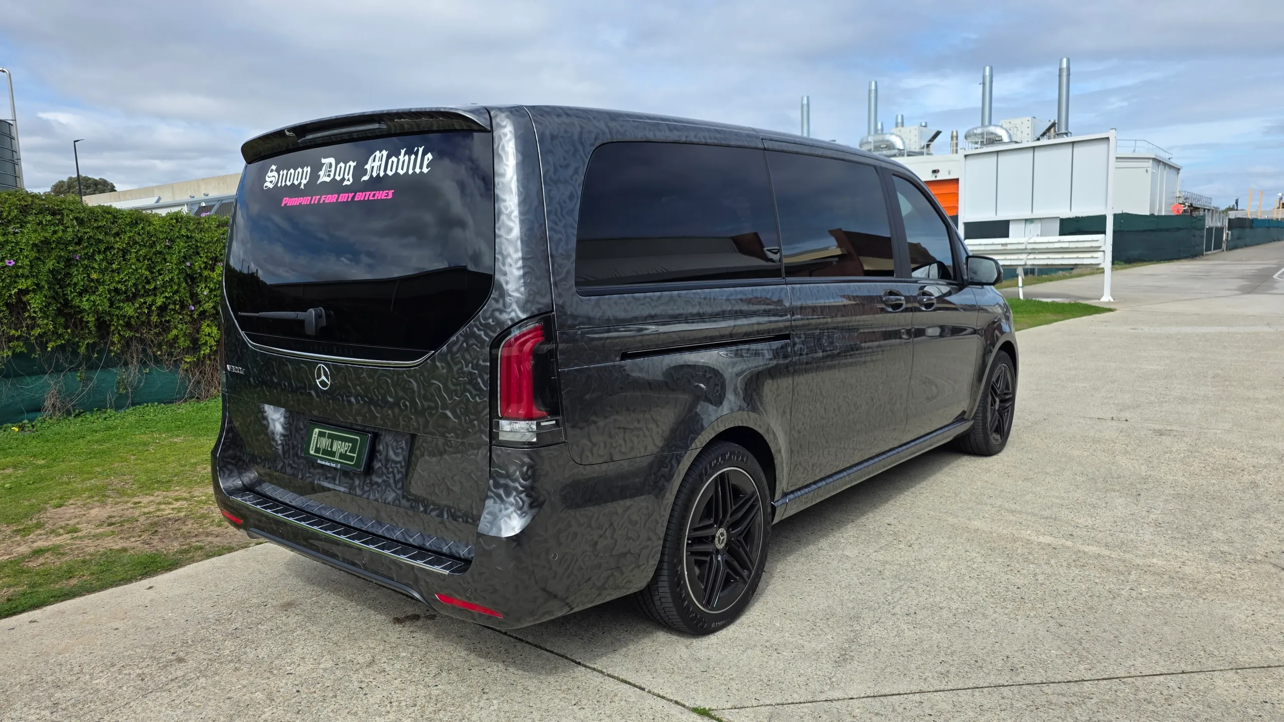 Patterned grey Mercedes-Benz V-Class viewed from the rear, with a custom rear-window decal