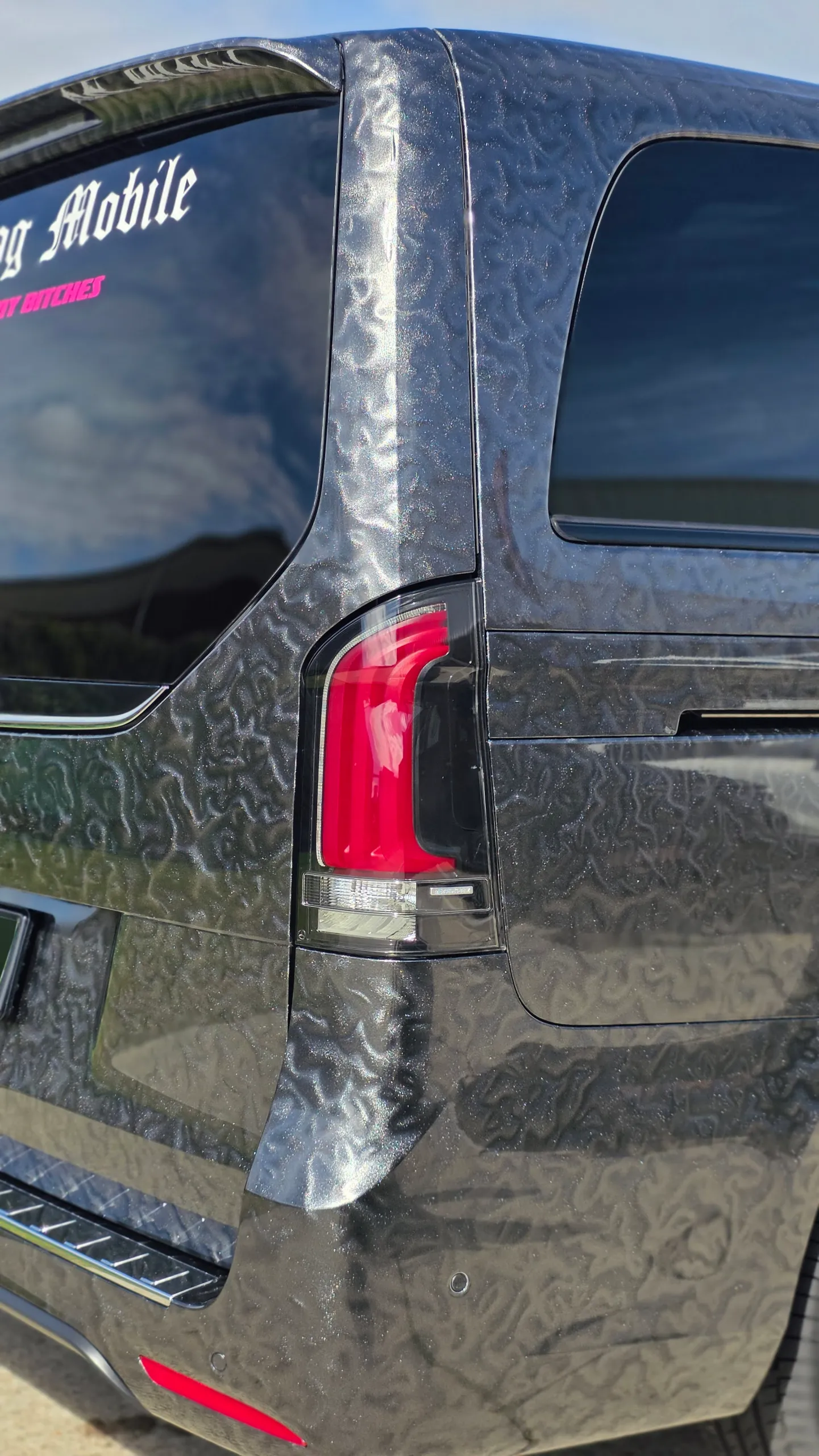 Patterned grey Mercedes-Benz V-Class rear pillar and tail light outdoors