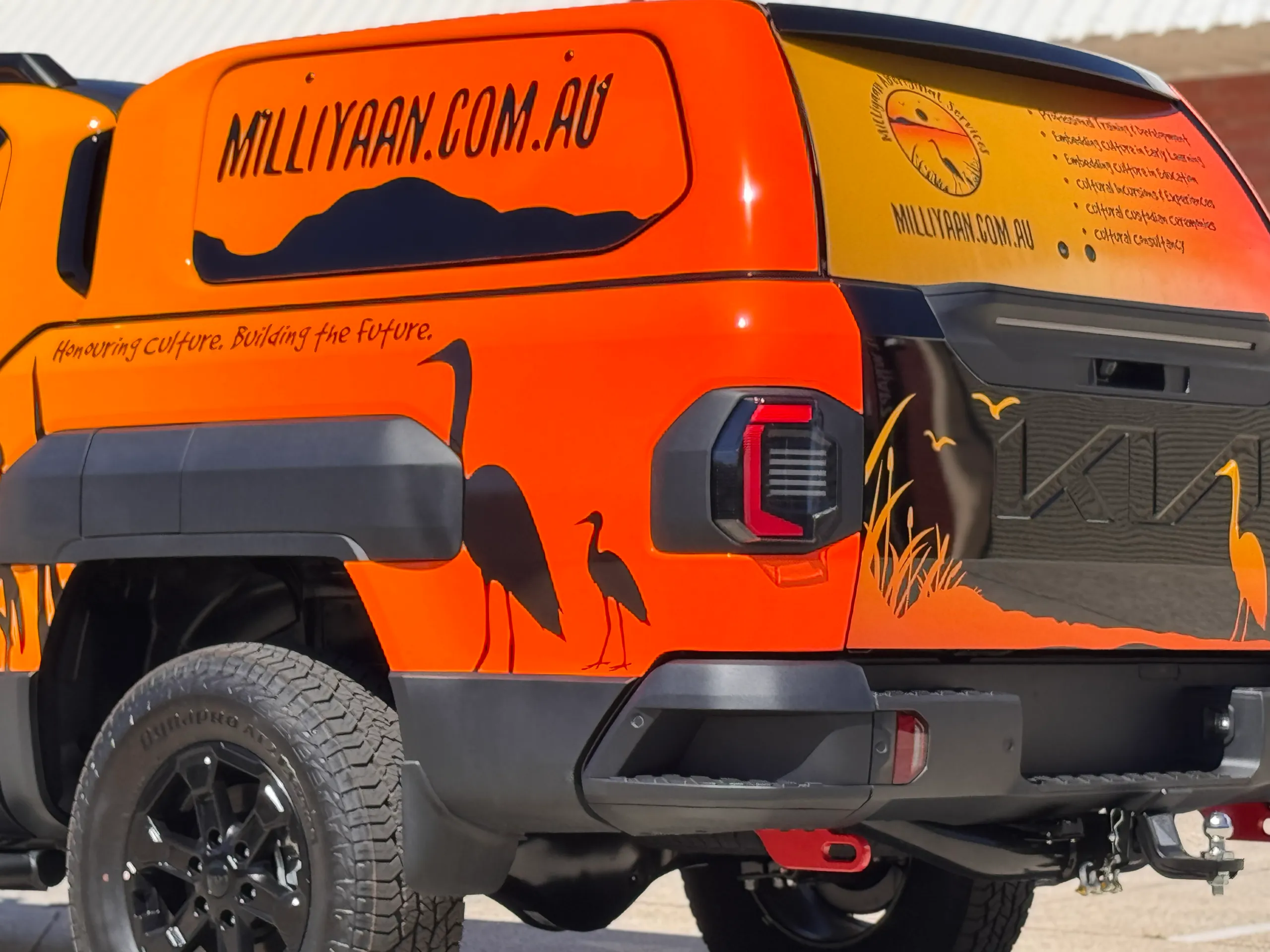 Milliyaan branding and black bird silhouettes across the Kia Tasman canopy and tailgate
