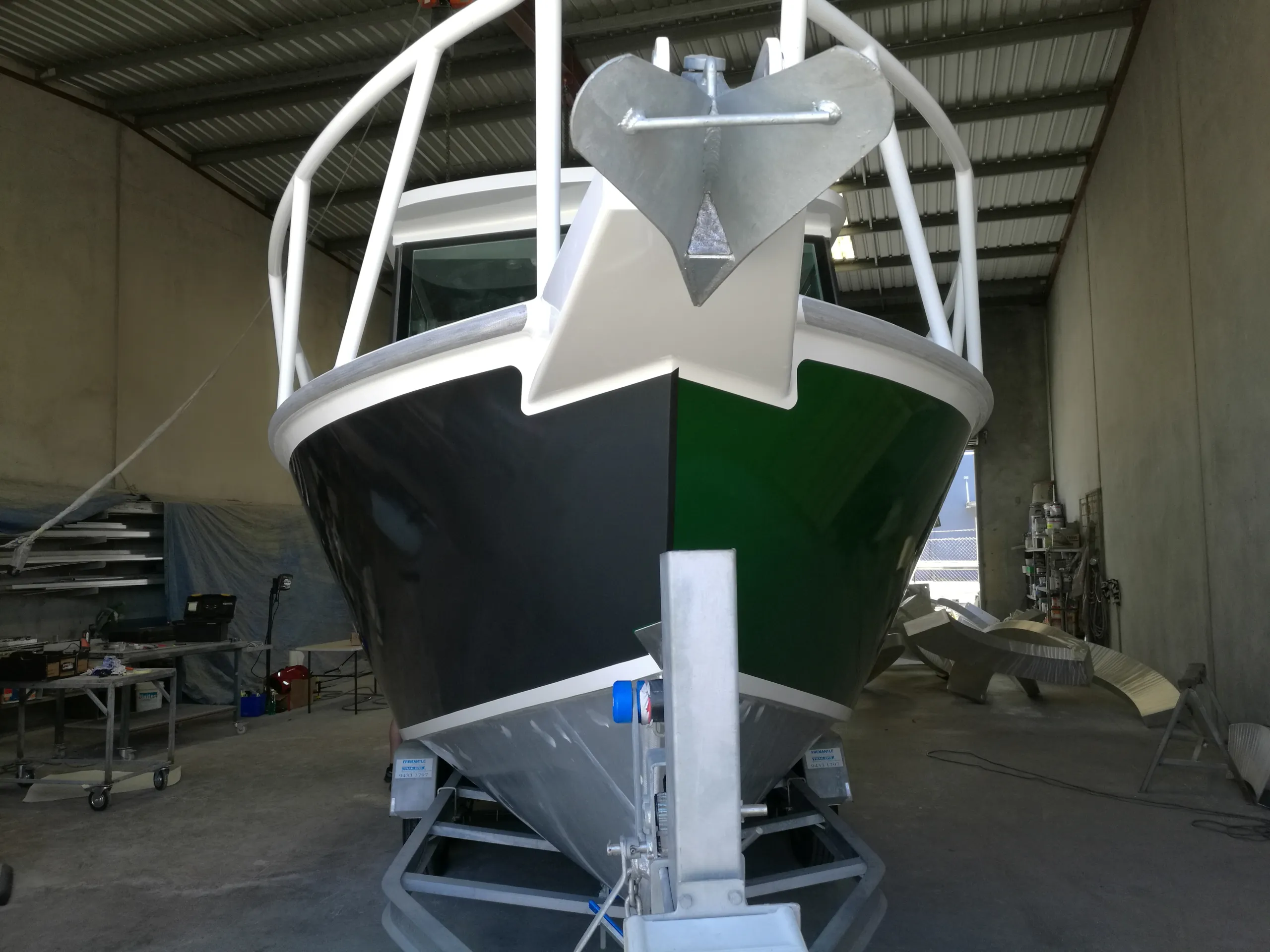 Boat bow during colour change, with one side charcoal and the other still green
