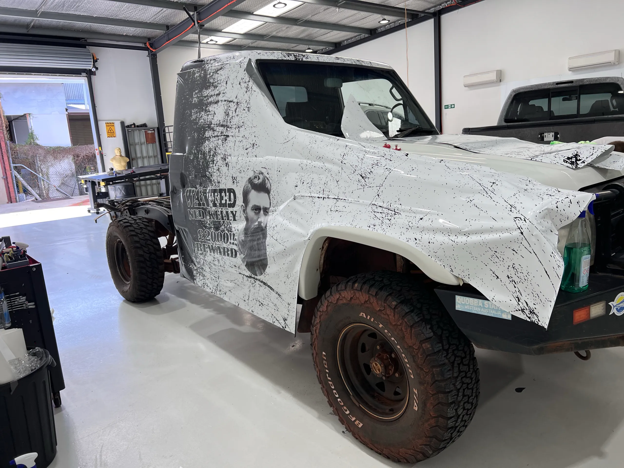 Ned Kelly printed cab wrap being fitted with front trim removed