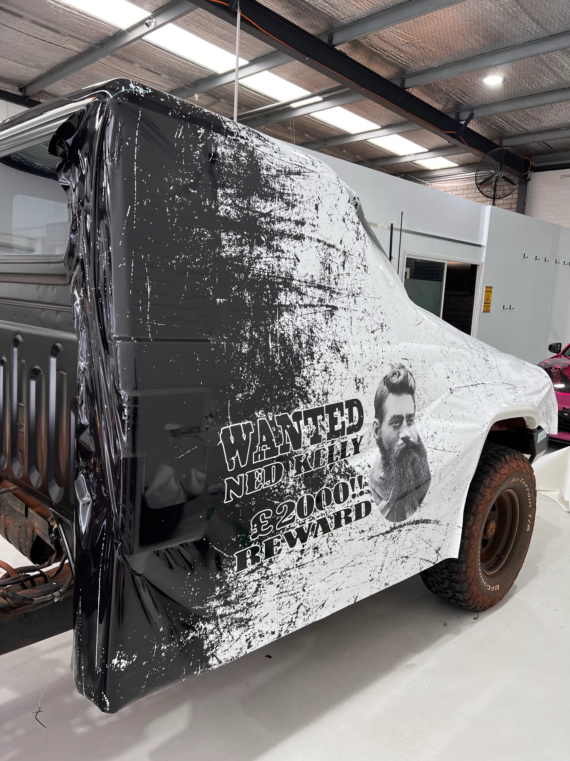 Printed black film partly fitted across the LandCruiser cab side