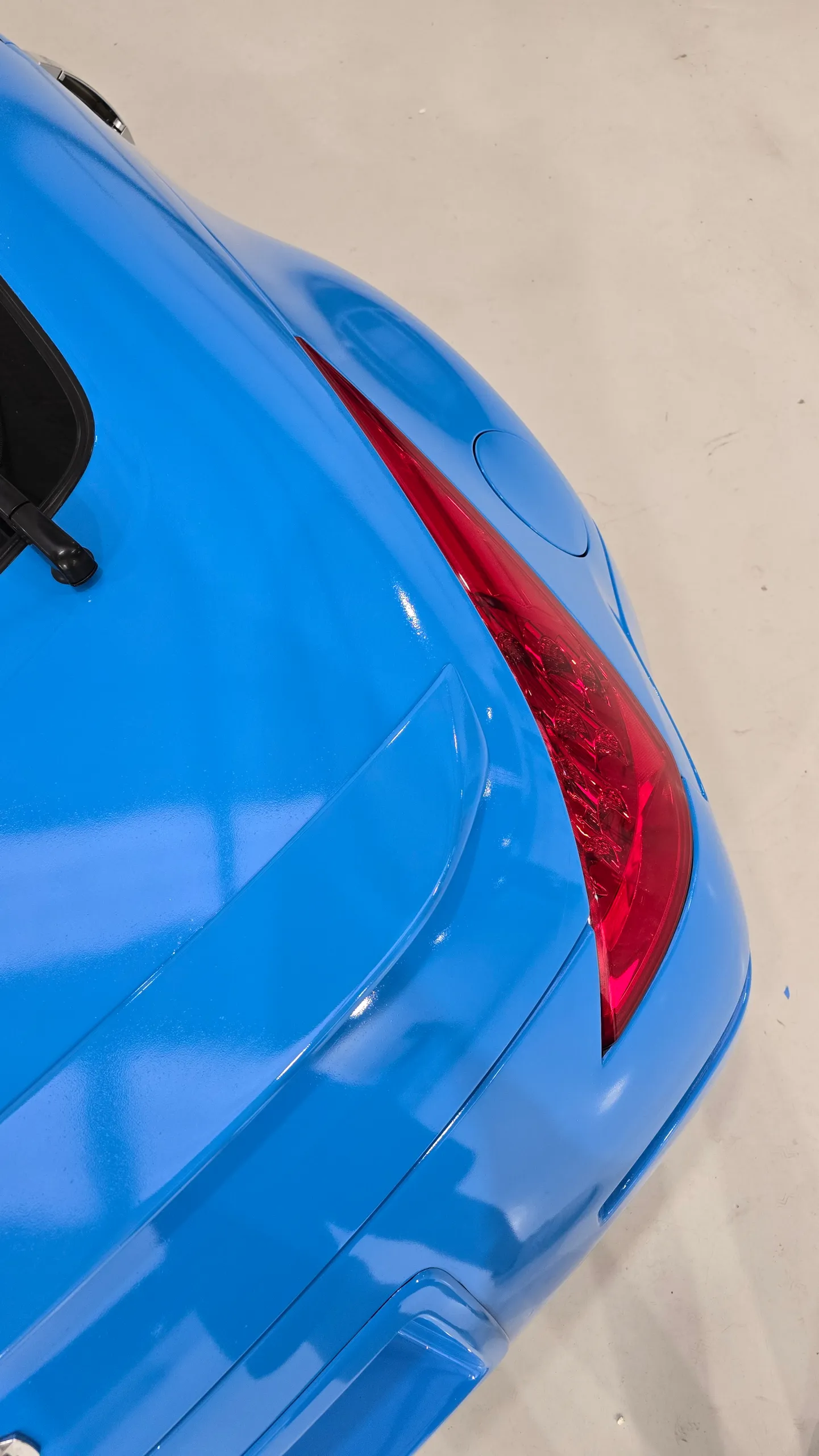 Gloss light blue Nissan 350Z in the workshop, rear detail