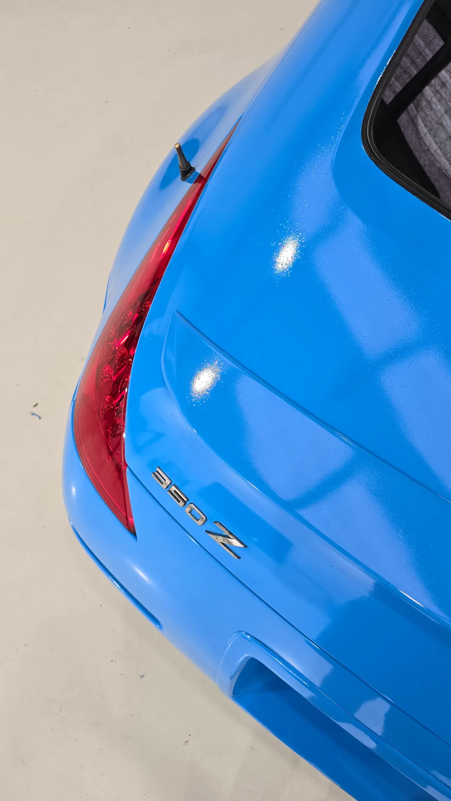 Gloss light blue Nissan 350Z in the workshop, rear detail