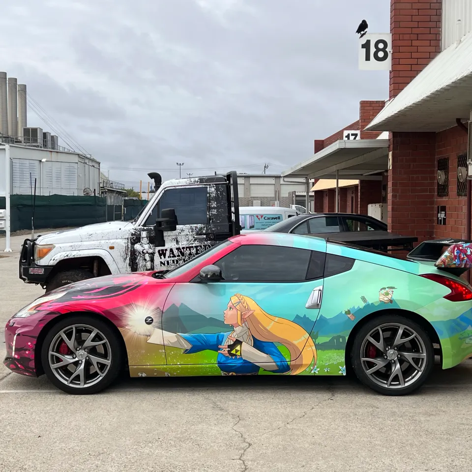 Side view of the Nissan 370Z showing turquoise Zelda character graphics and its rear wing
