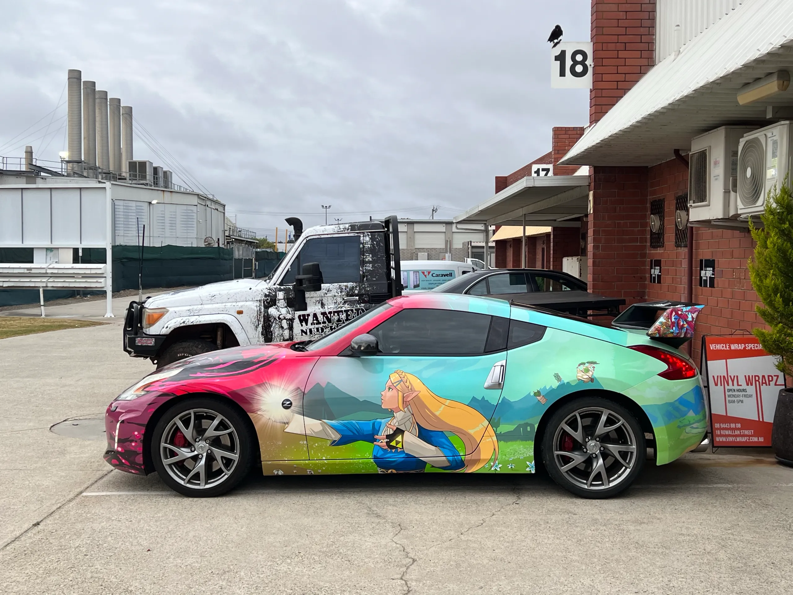 Side view of the Nissan 370Z showing turquoise Zelda character graphics and its rear wing