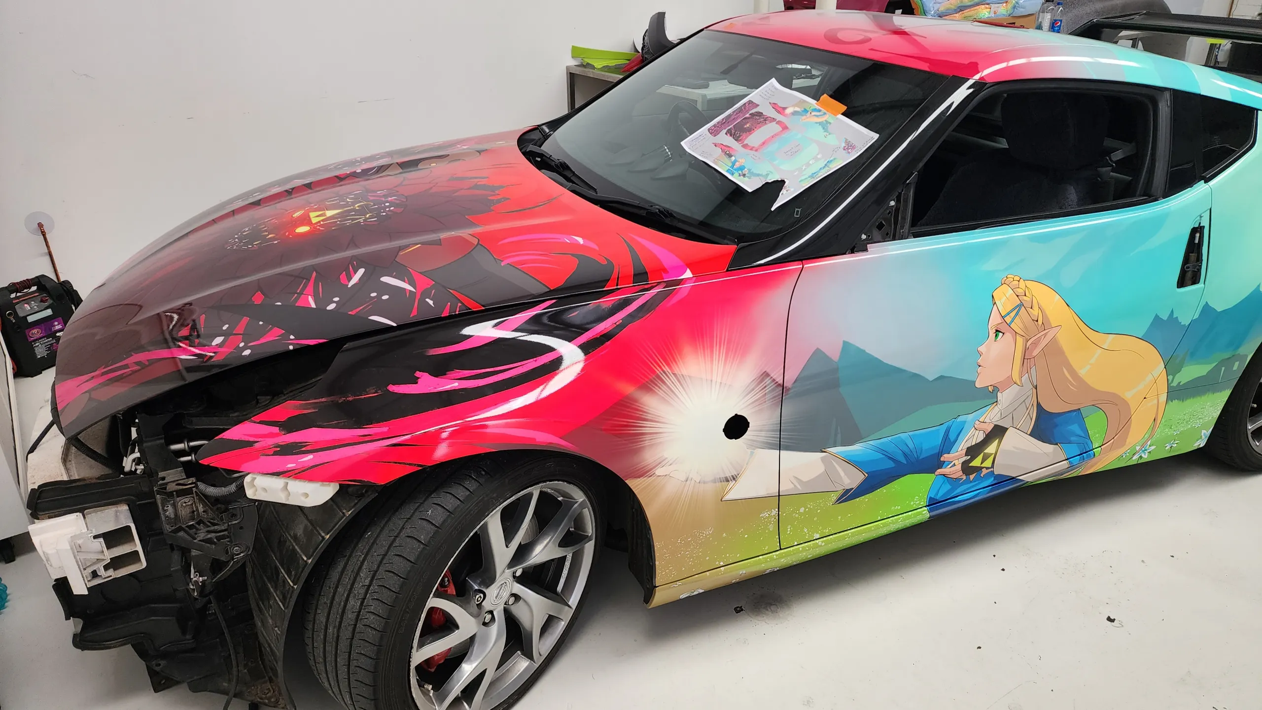 Nissan 370Z with its bumper removed during printed wrap installation