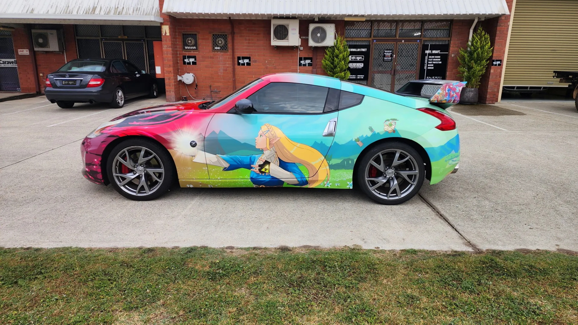 Turquoise character artwork along the Nissan doors and rear quarter