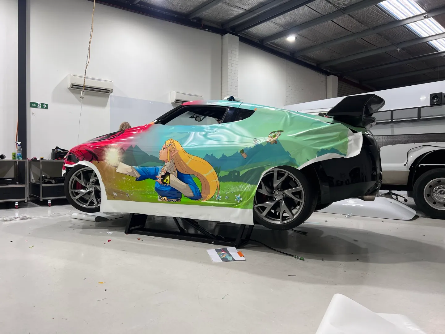 Printed film partly fitted across the Nissan side in the workshop