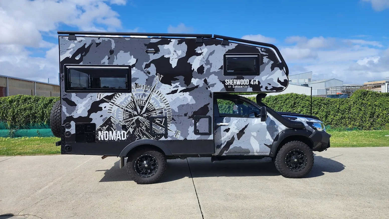 Sherwood 4x4 camper in a custom Nomad camouflage compass wrap