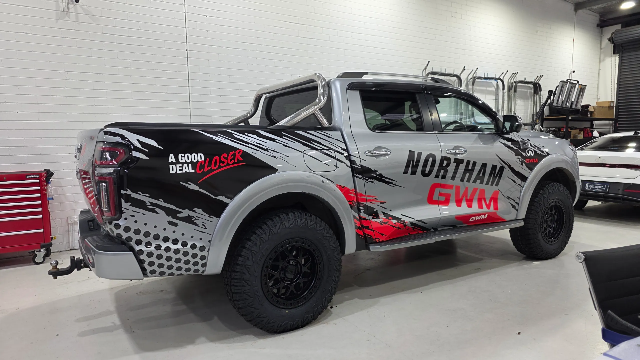 Northam GWM Cannon ute with black and red graphics along its silver body in the workshop