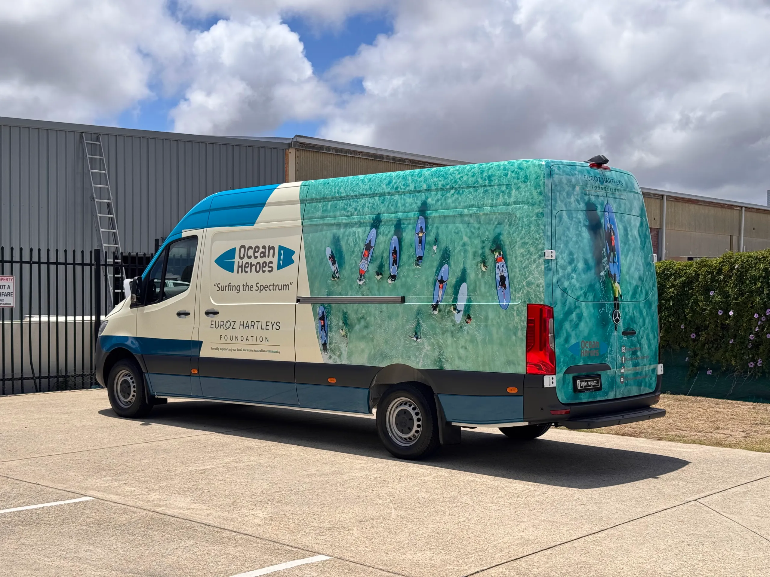Ocean Heroes van parked outside, showing rear and side graphics