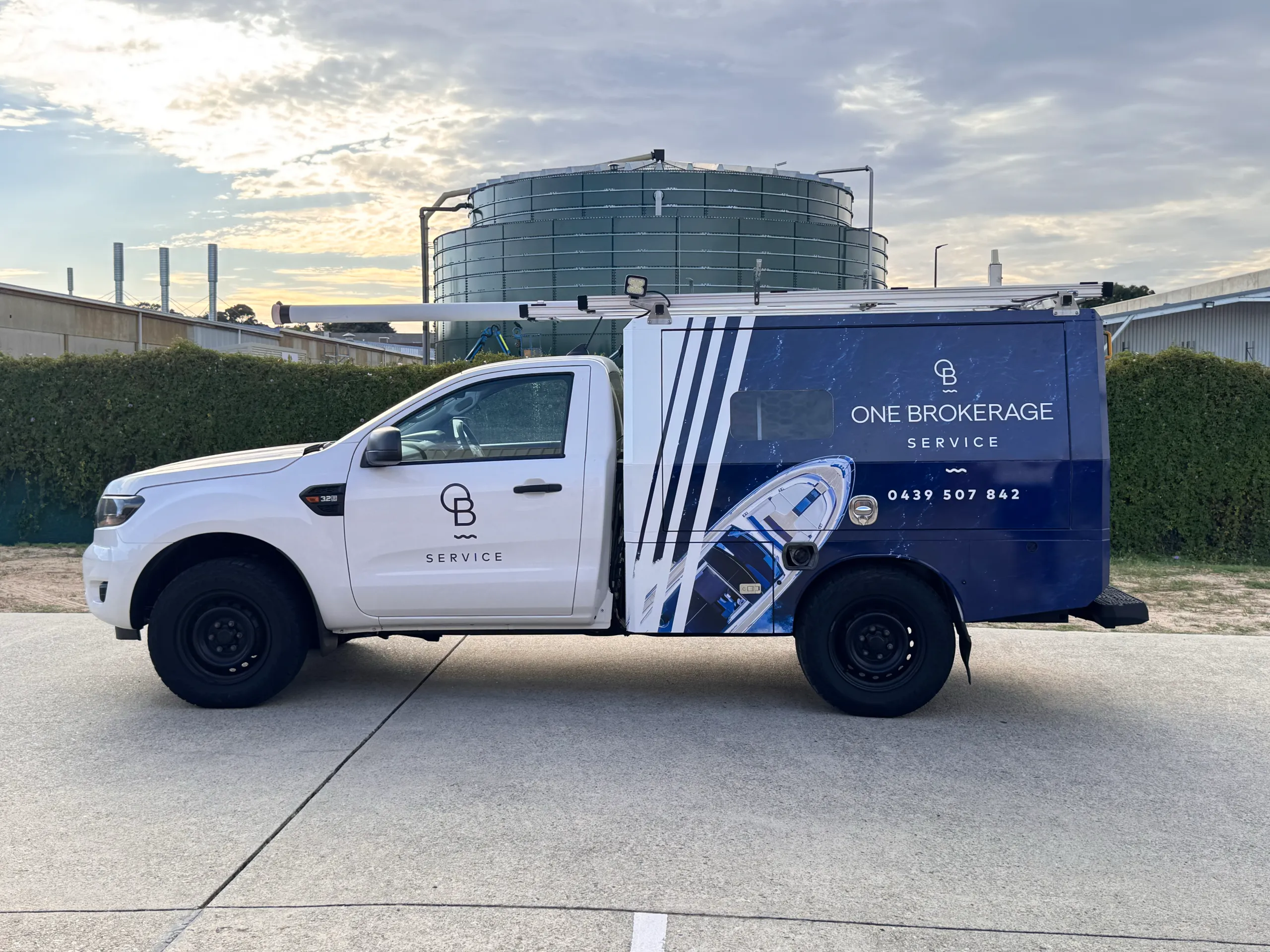 One Brokerage Service Ford Ranger with a blue wrapped service canopy and white cab