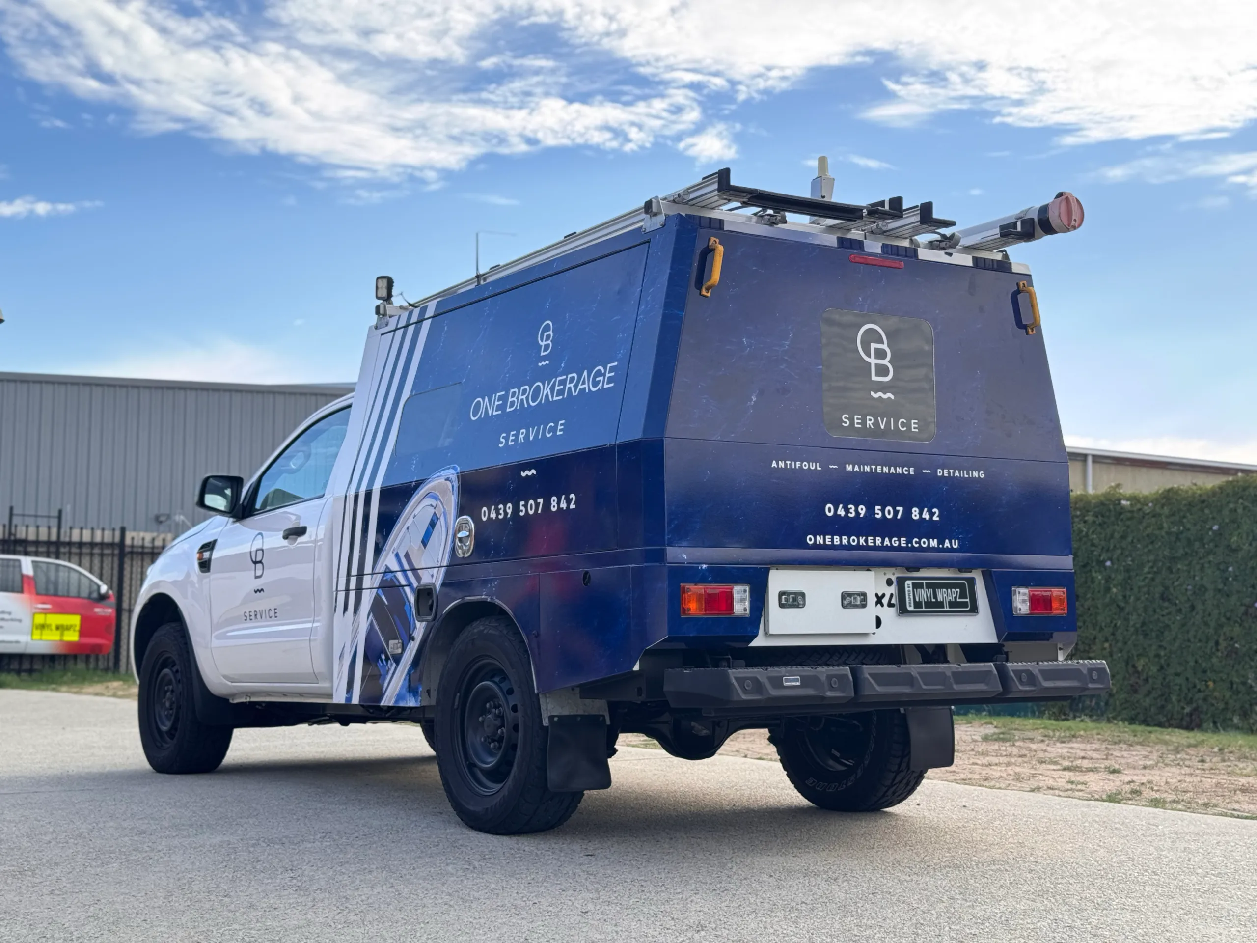 Blue One Brokerage Service graphics across the Ford Ranger canopy, viewed from the rear quarter