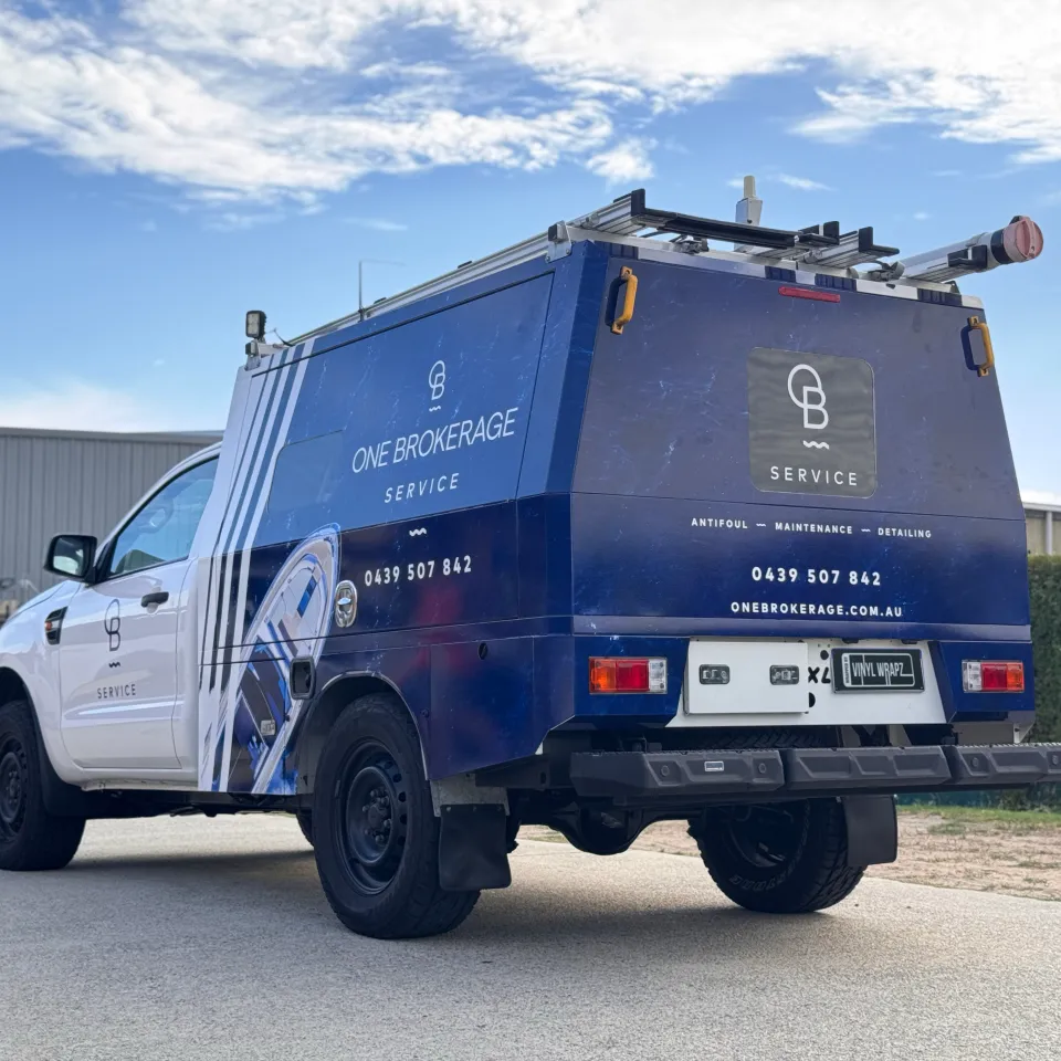 Blue One Brokerage Service graphics across the Ford Ranger canopy, viewed from the rear quarter