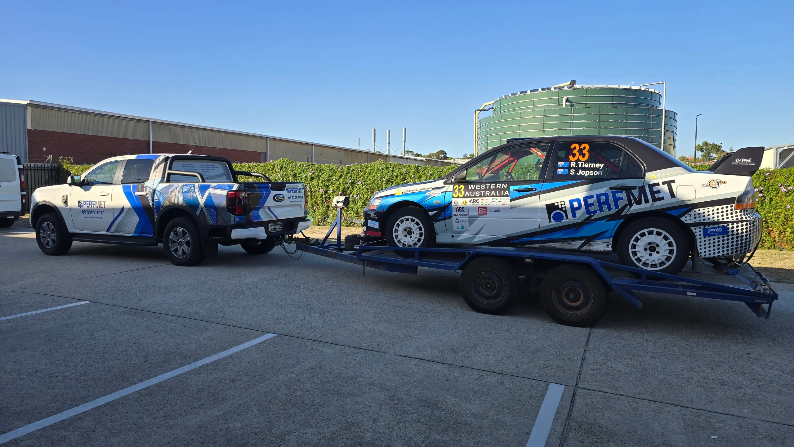 Perfmet Ford Ranger and trailered Mitsubishi Evo rally car with matching blue and white graphics