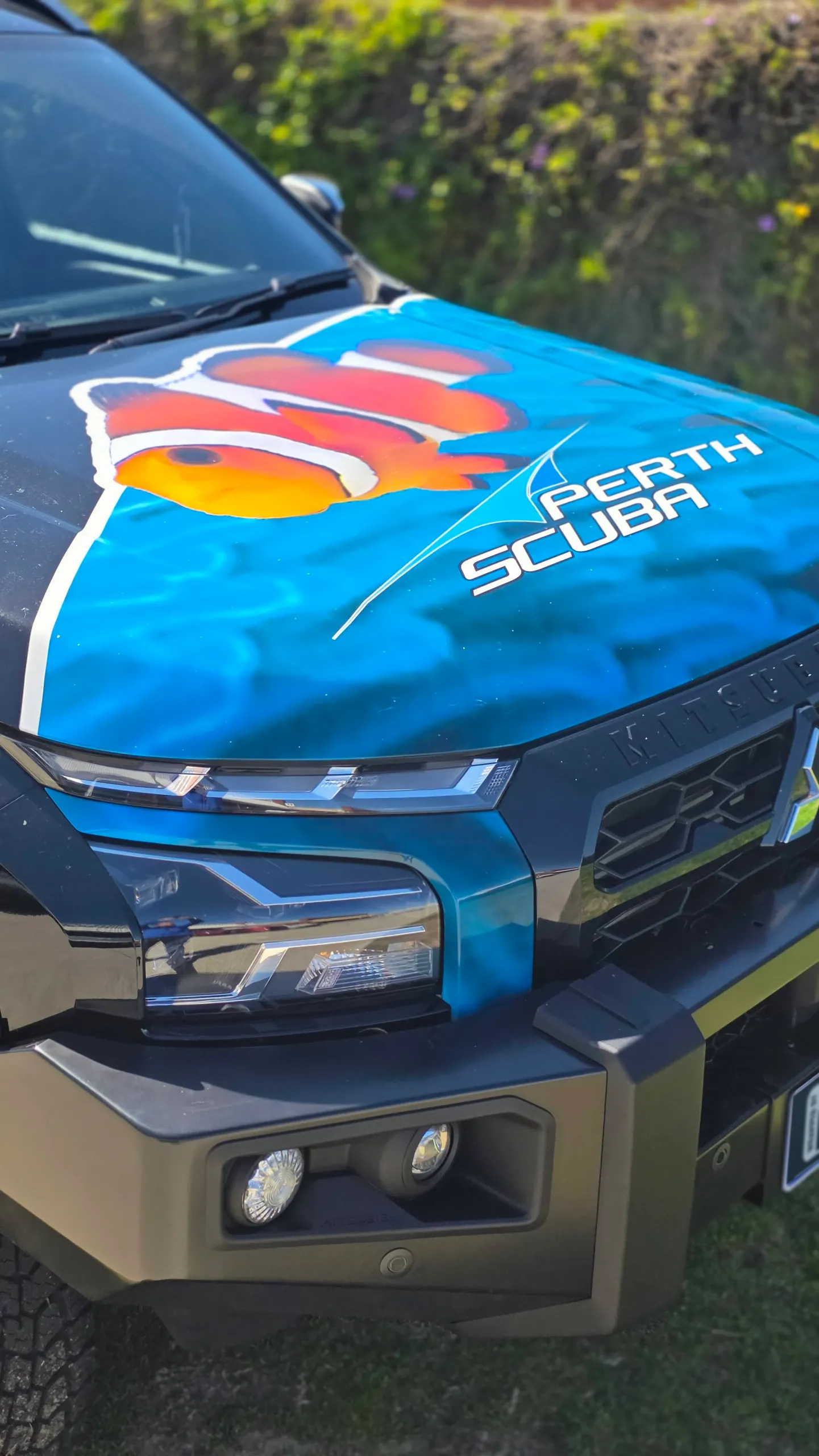 Blue water and clownfish graphics with Perth Scuba lettering on the Triton bonnet