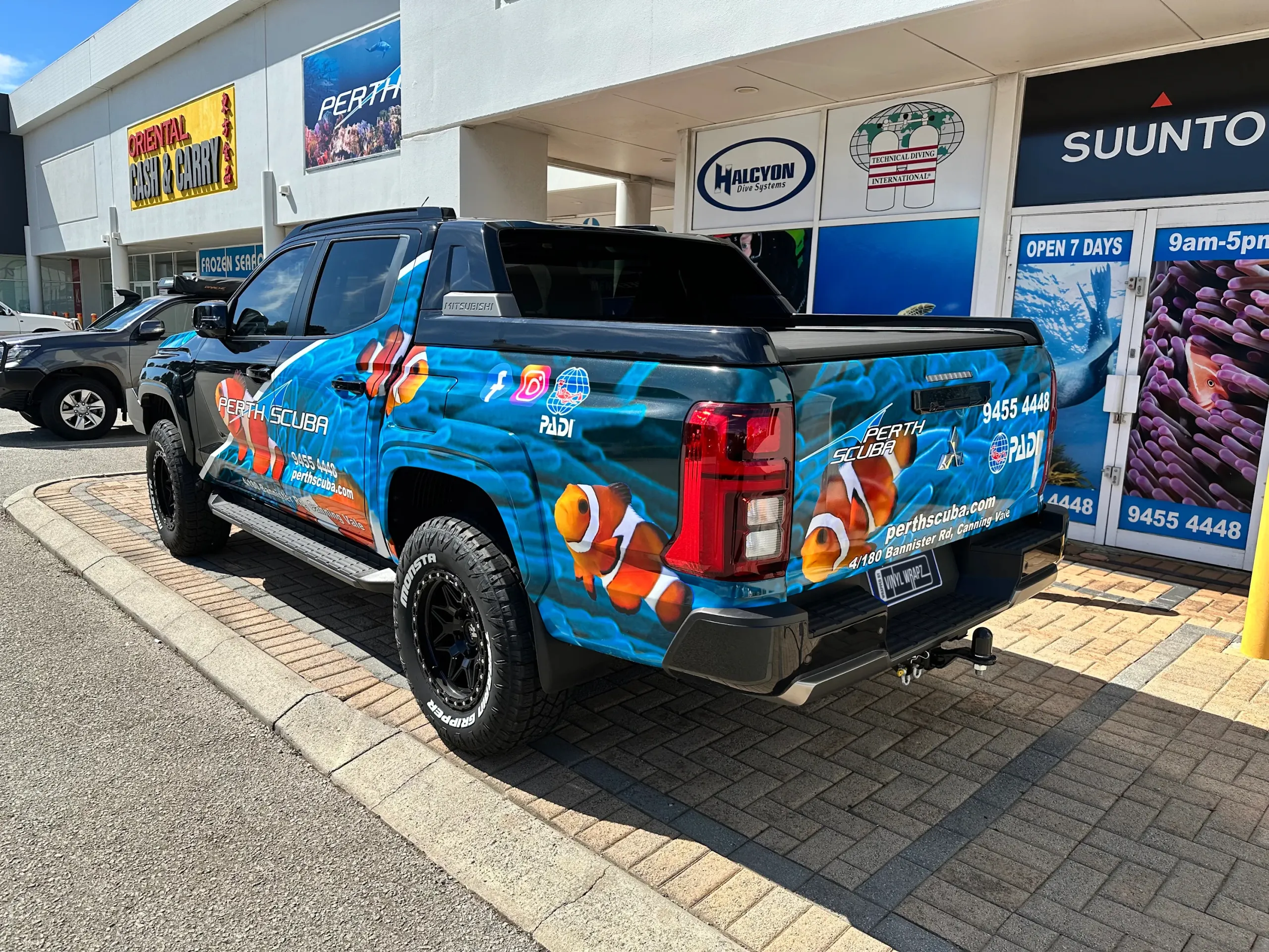 Perth Scuba Triton rear quarter with clownfish graphics outside the dive shop