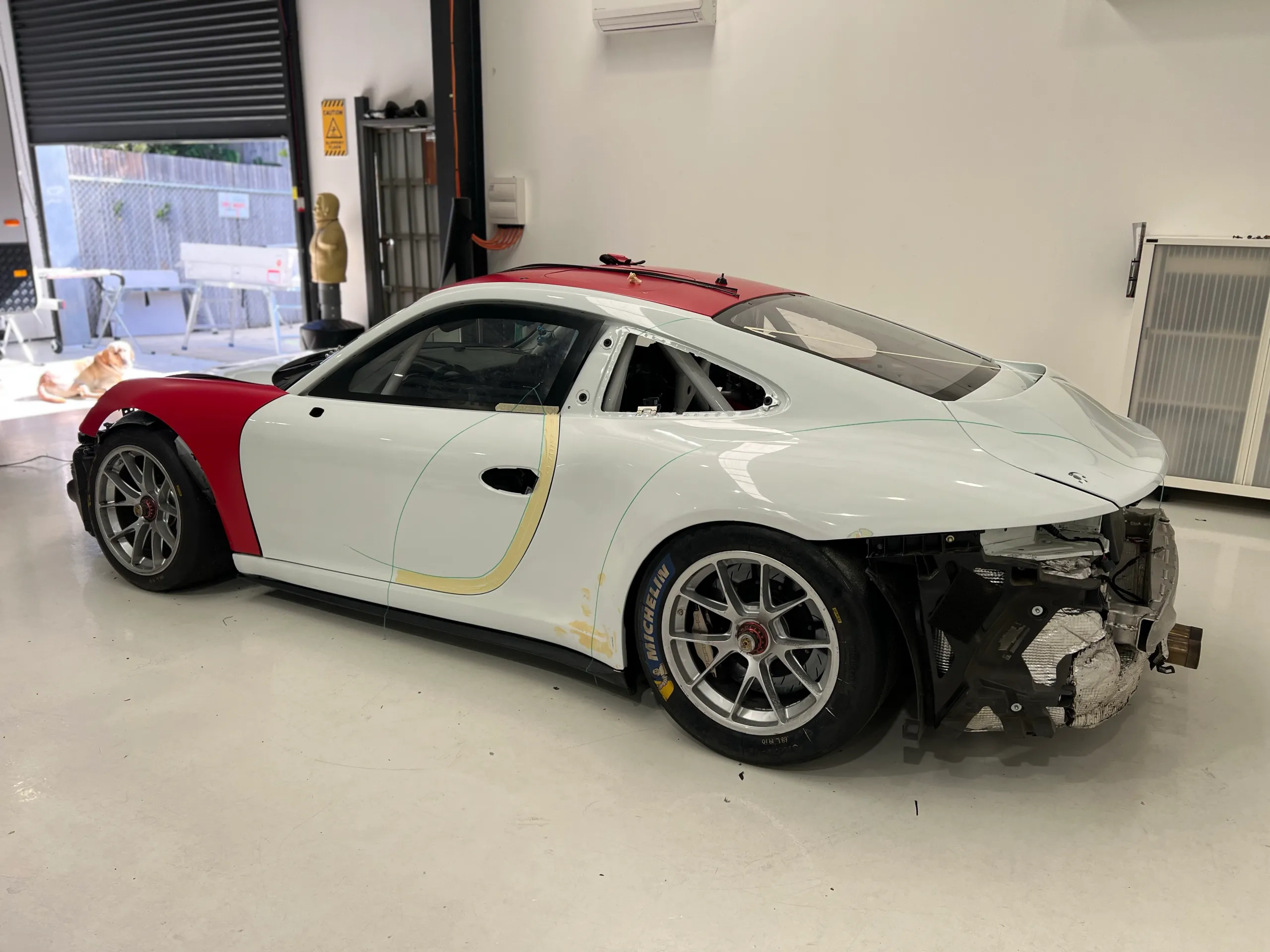 Porsche 911 in the workshop with trim removed before wrapping