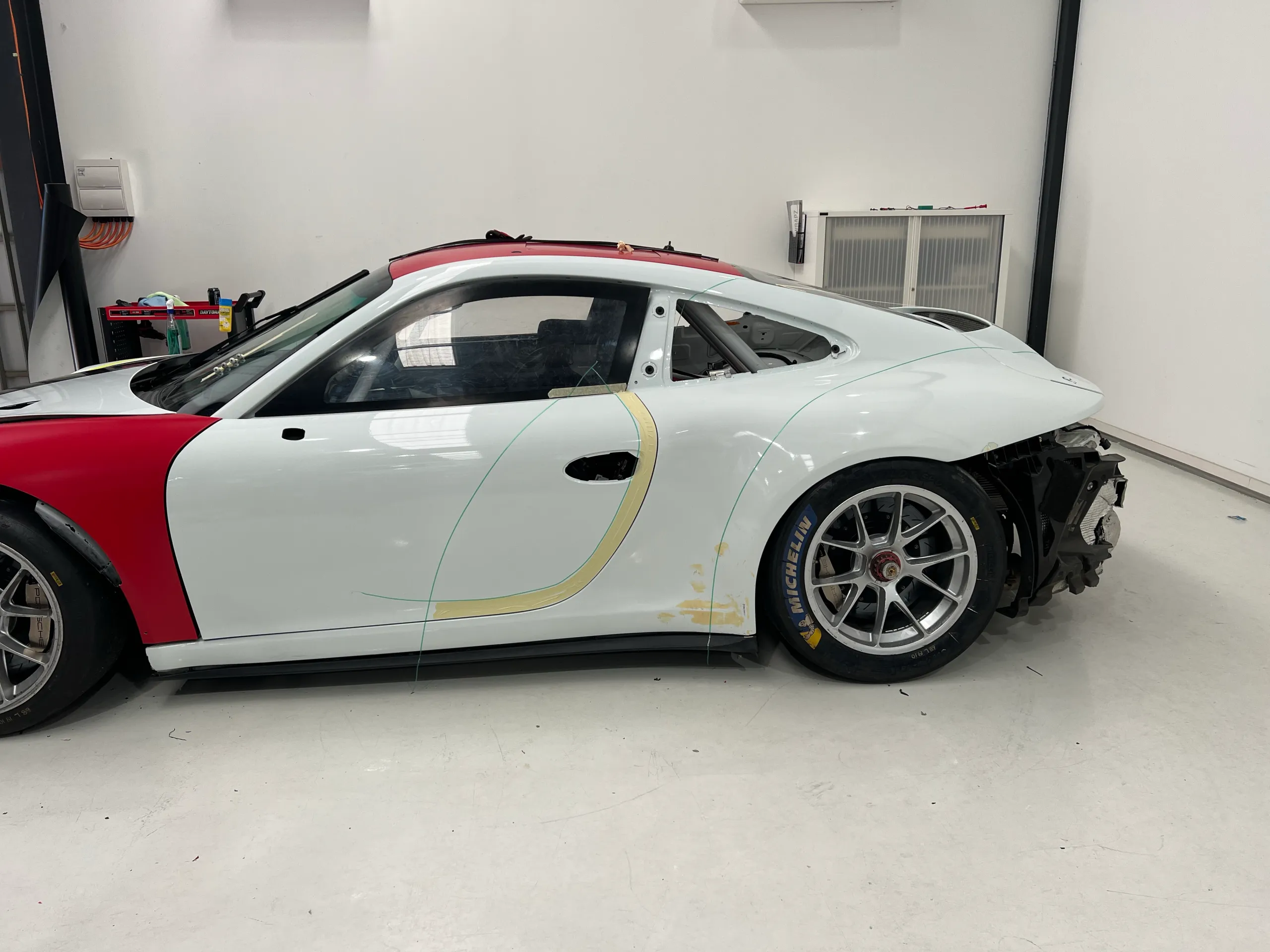 Closer rear-quarter view of the Porsche during preparation