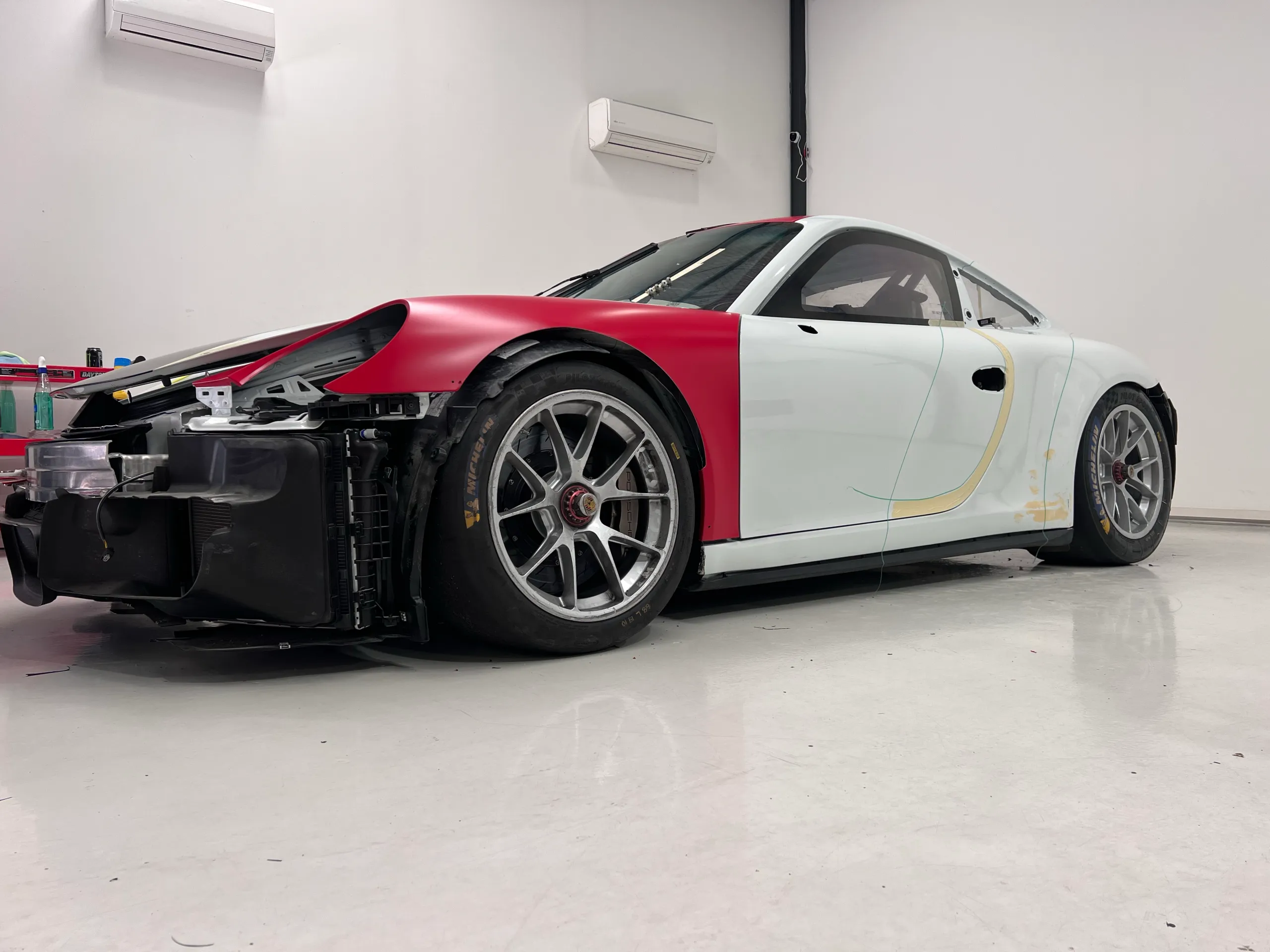 Low front view of the Porsche with its bumper removed