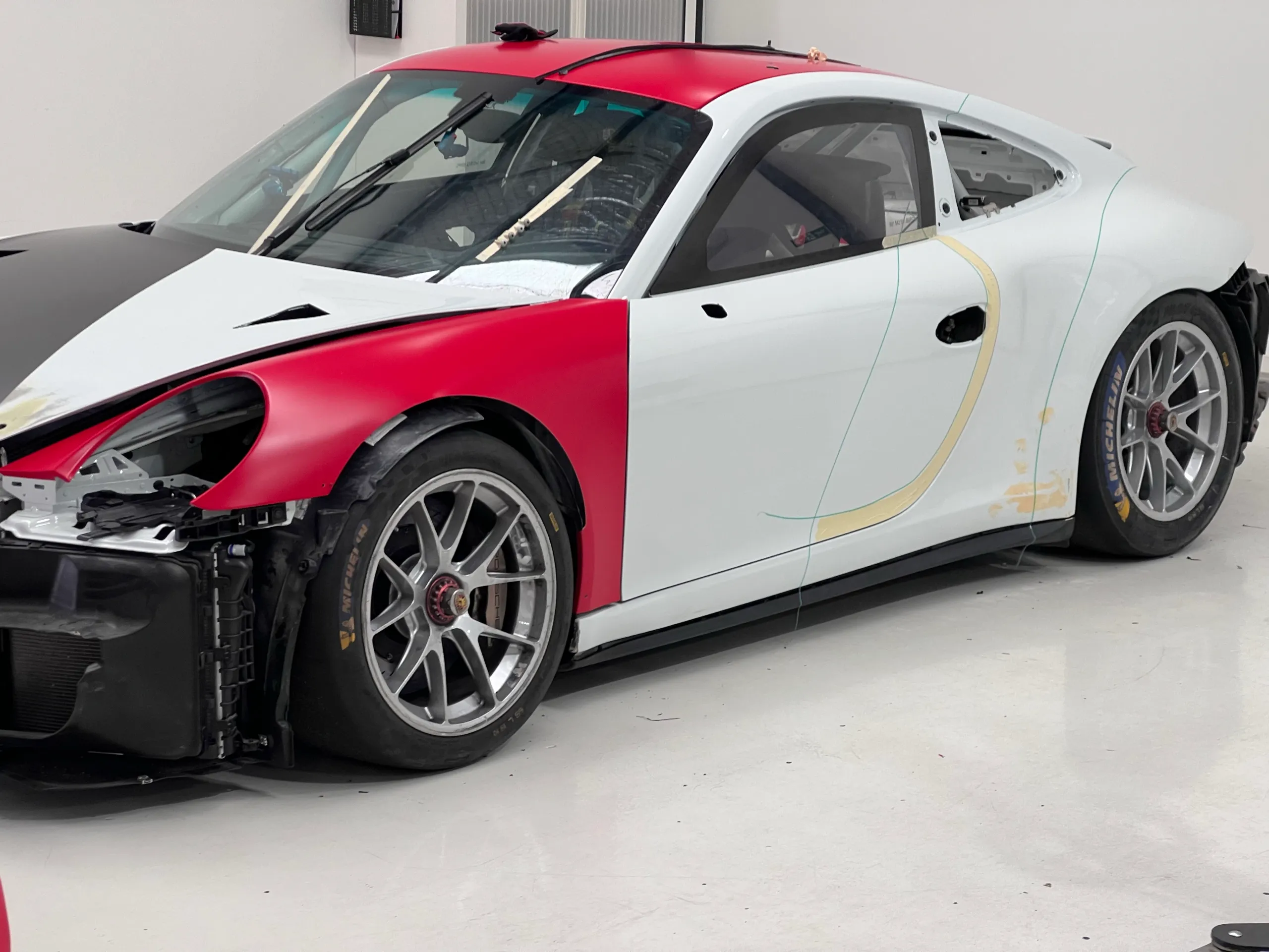 Porsche front-quarter view during workshop preparation