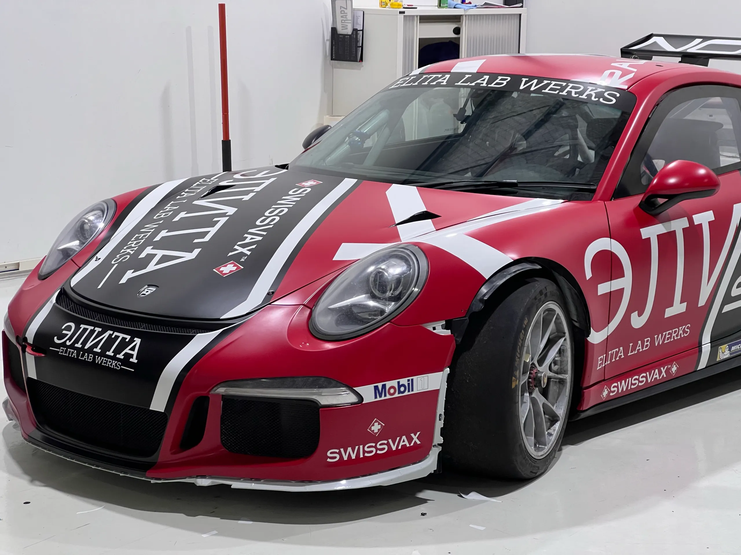 Close view of the fitted front race livery in the workshop