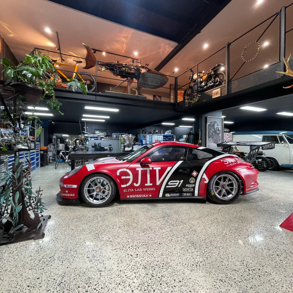 Wide side view of the Porsche race livery in the showroom