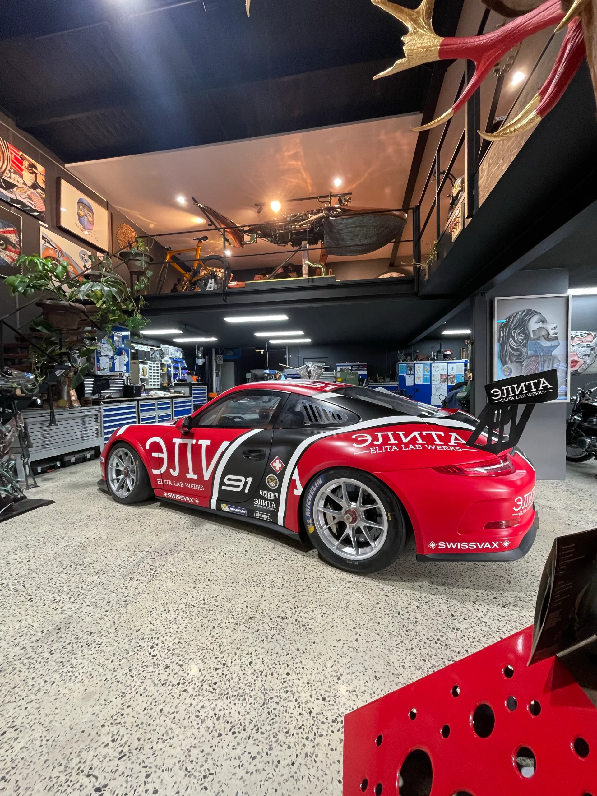 Rear-quarter view of the completed race livery in the showroom