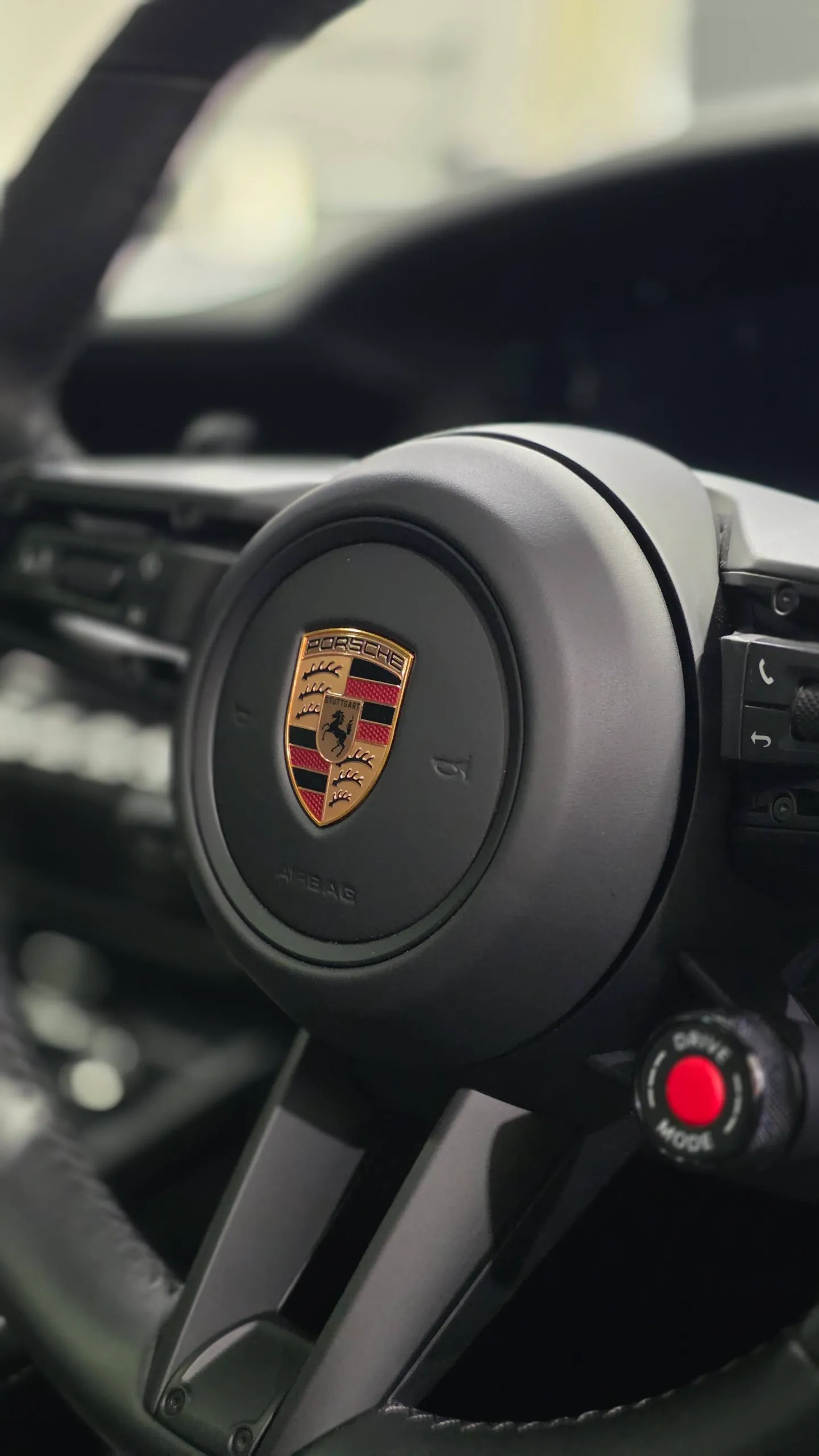 Porsche crest on the 911 Carrera GTS steering wheel