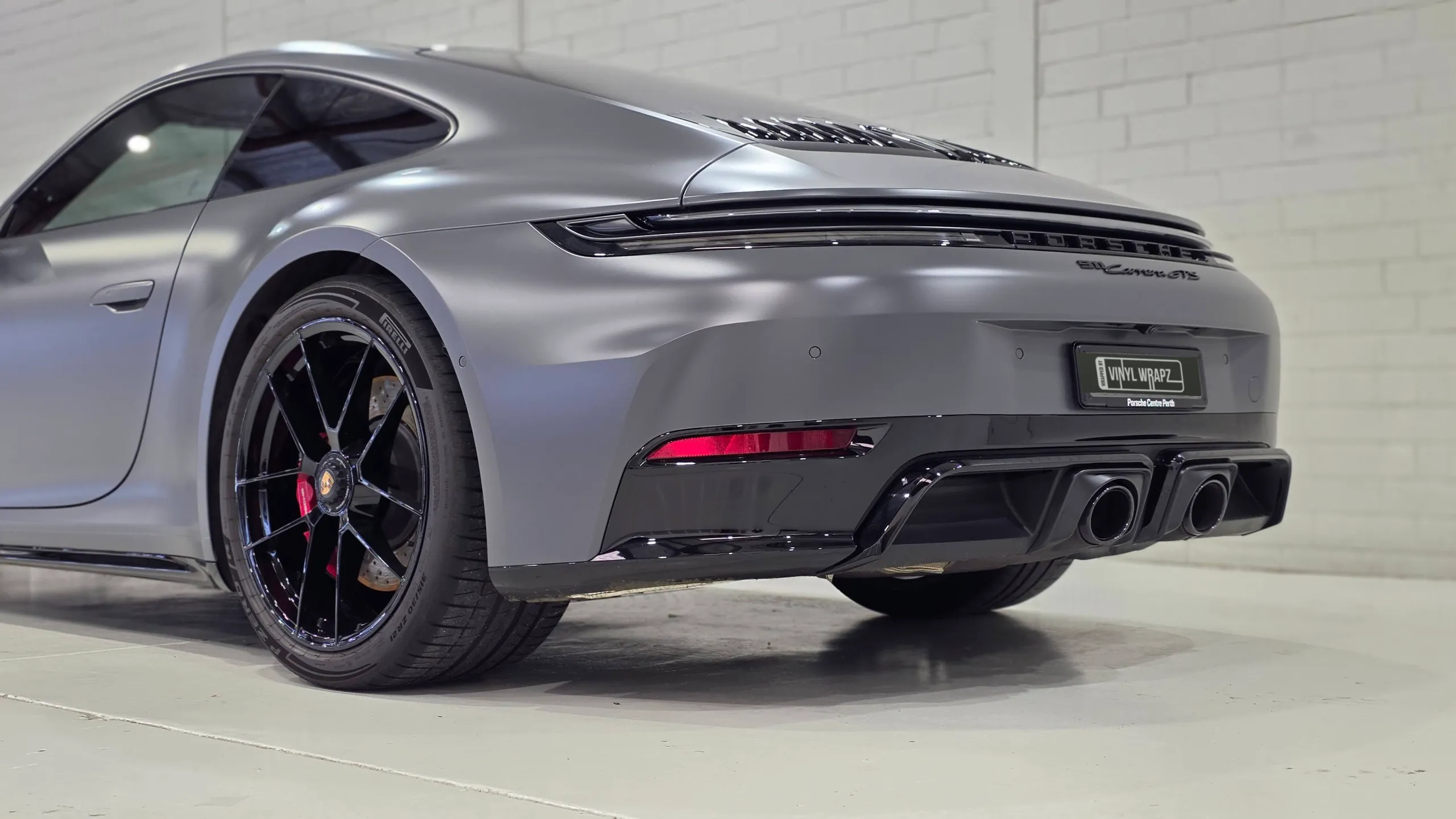 Satin grey Porsche 911 Carrera GTS rear bumper, wheel and twin exhaust outlets