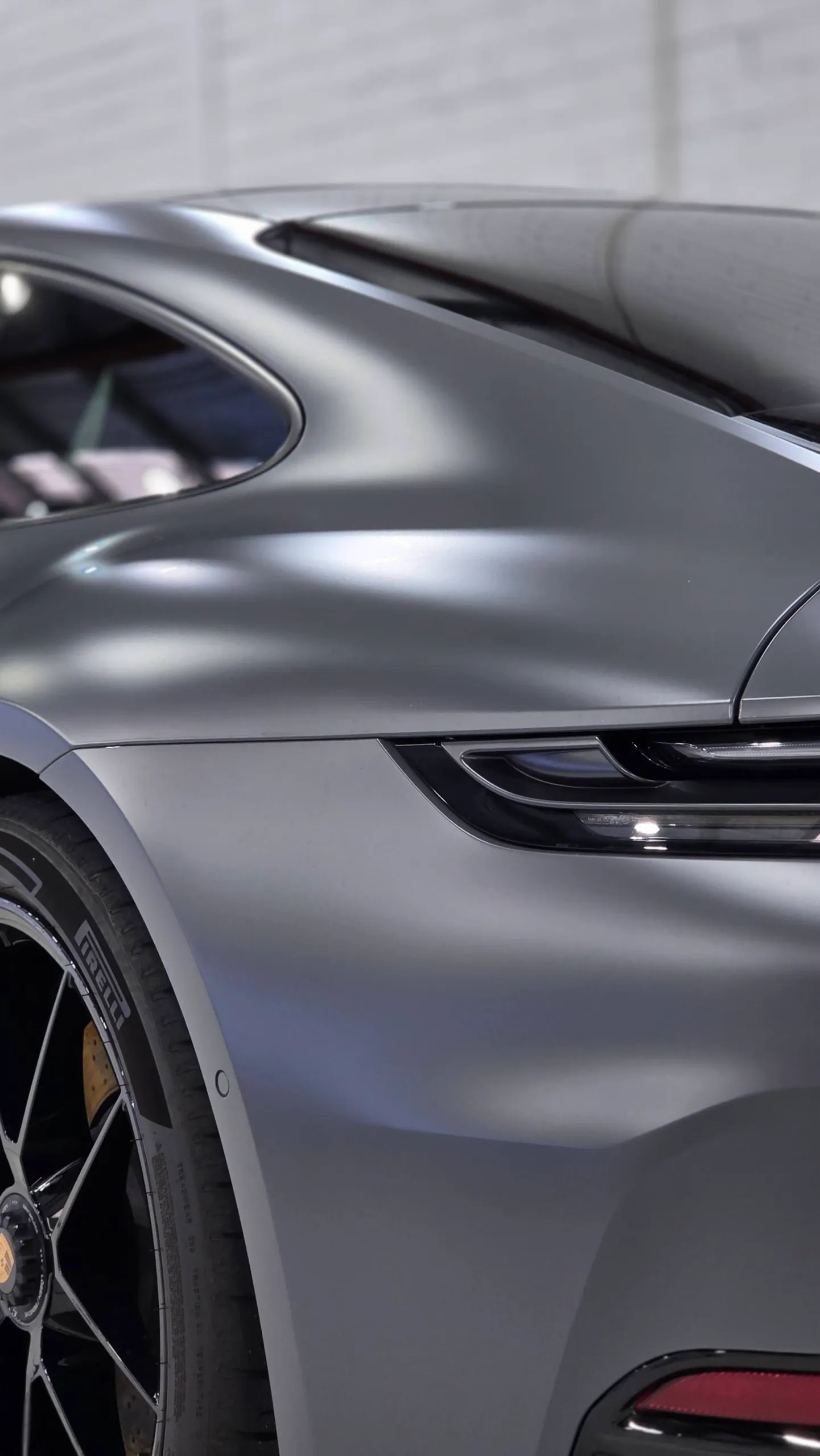 Satin grey finish across the Porsche 911 rear quarter beneath its side window