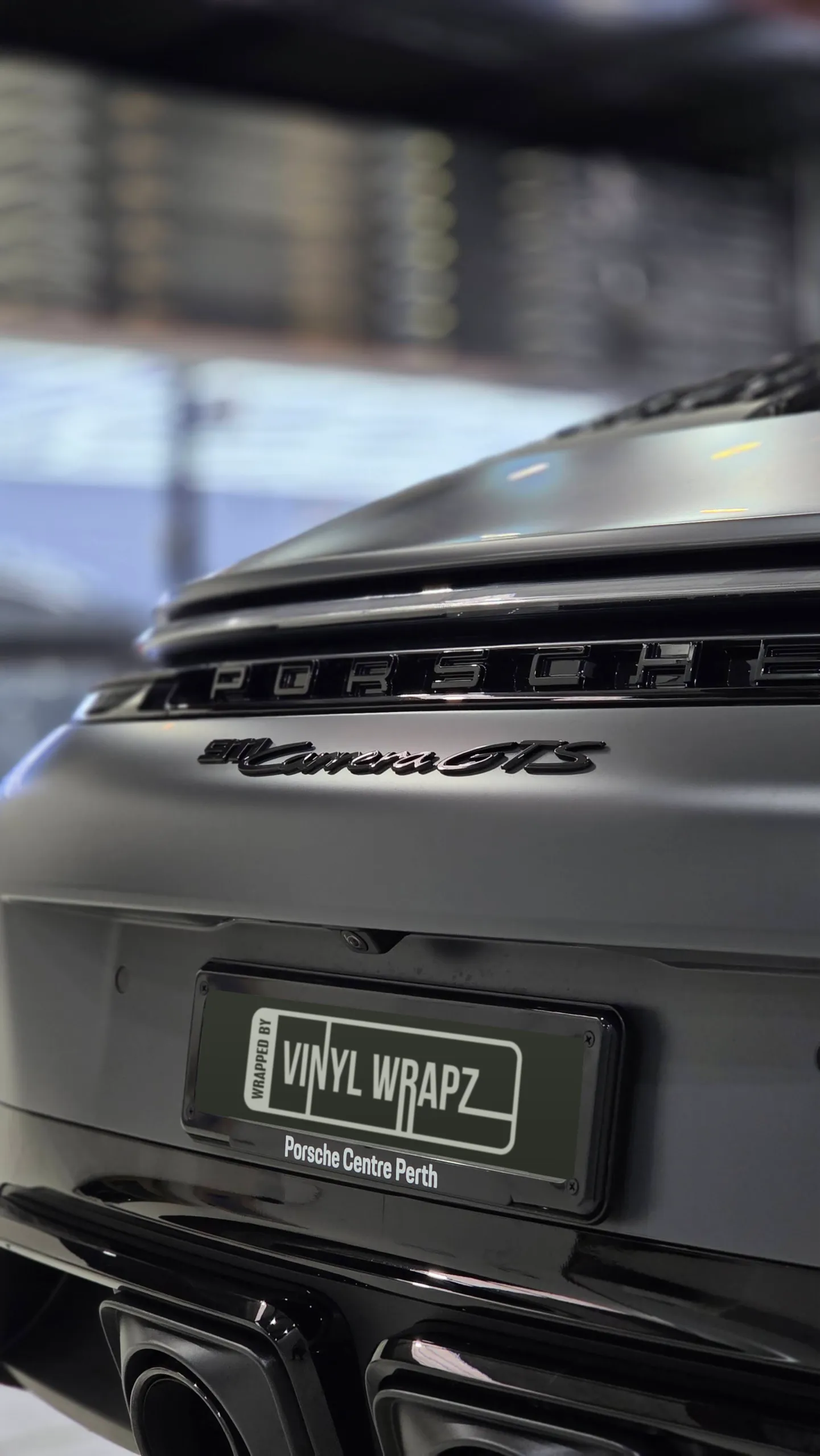 Porsche and Carrera GTS lettering across the satin grey rear panel